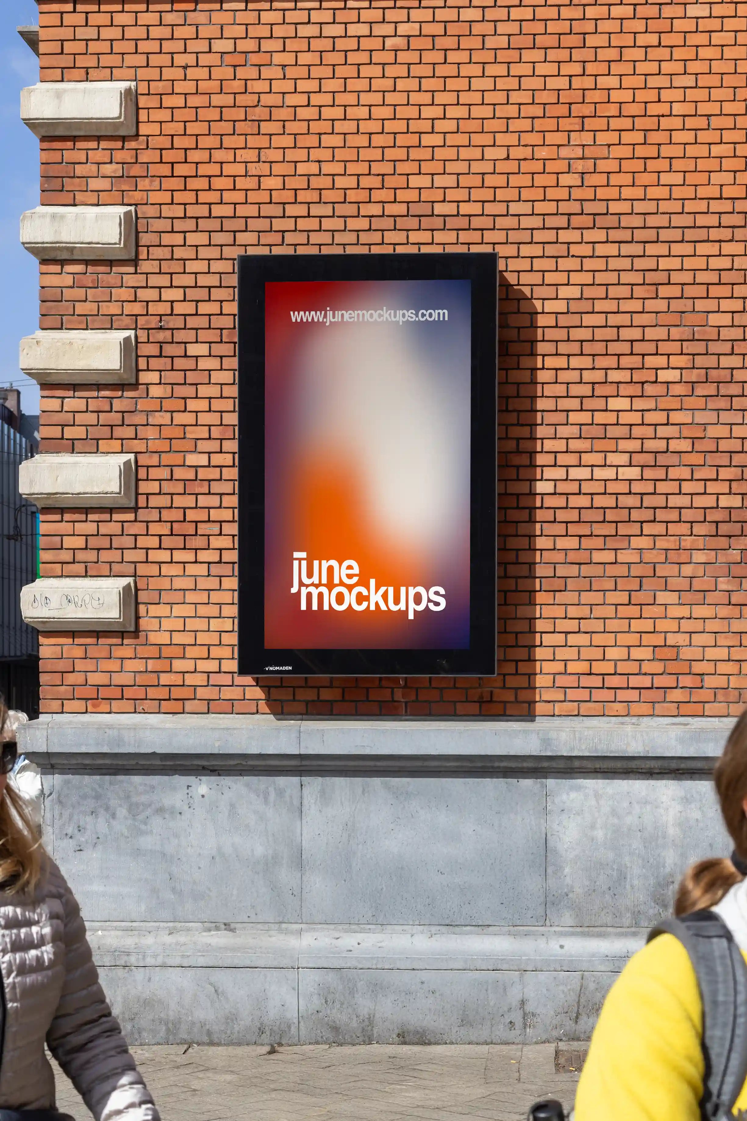 Amsterdam City Light Mockup mounted on red brick wall of Schouwburg Theater.