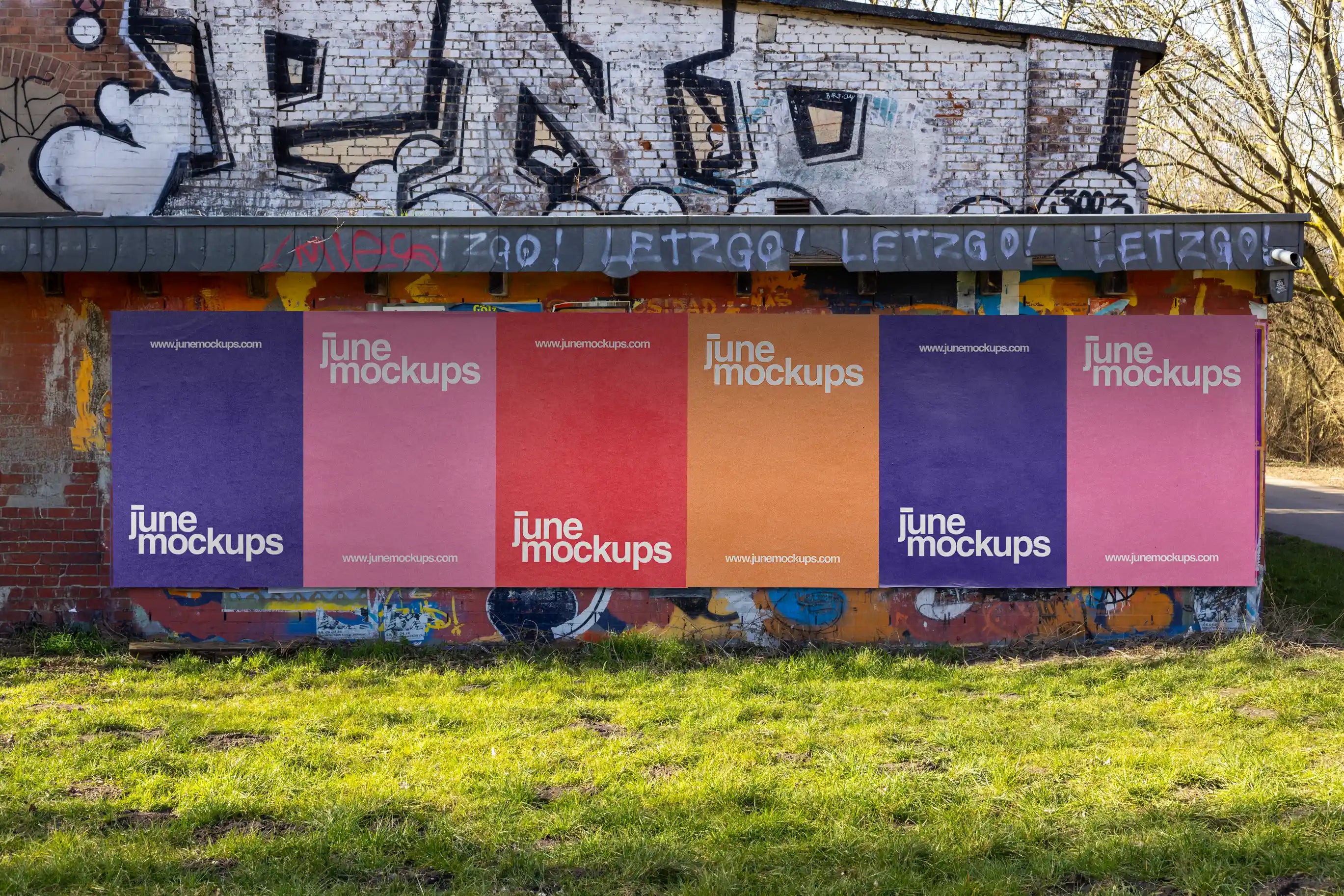 Vivid outdoor poster mockup featuring multiple colorful posters arranged on an urban wall with natural light and realistic paper texture. Great for advertising, branding, or campaign visuals in modern city settings.