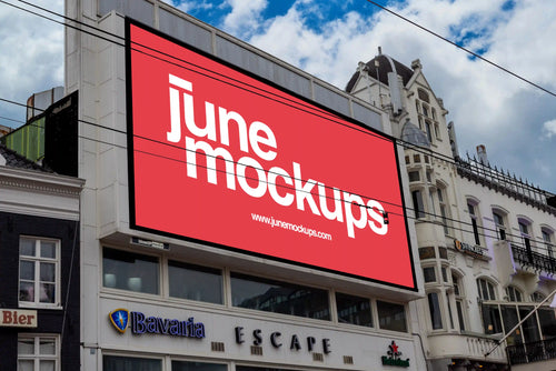 Large billboard mockup at Rembrandtplein in Amsterdam, located above Escape Club with red poster design.