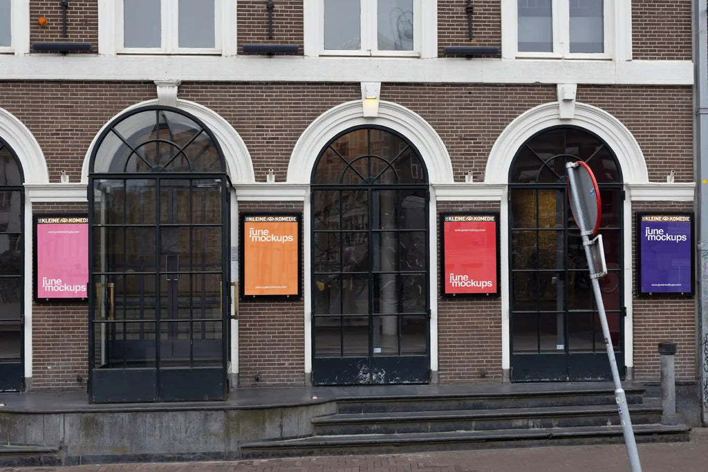 City light poster mockups at the entrance of De Kleine Komedie theater in Amsterdam, colorful posters under arched windows.