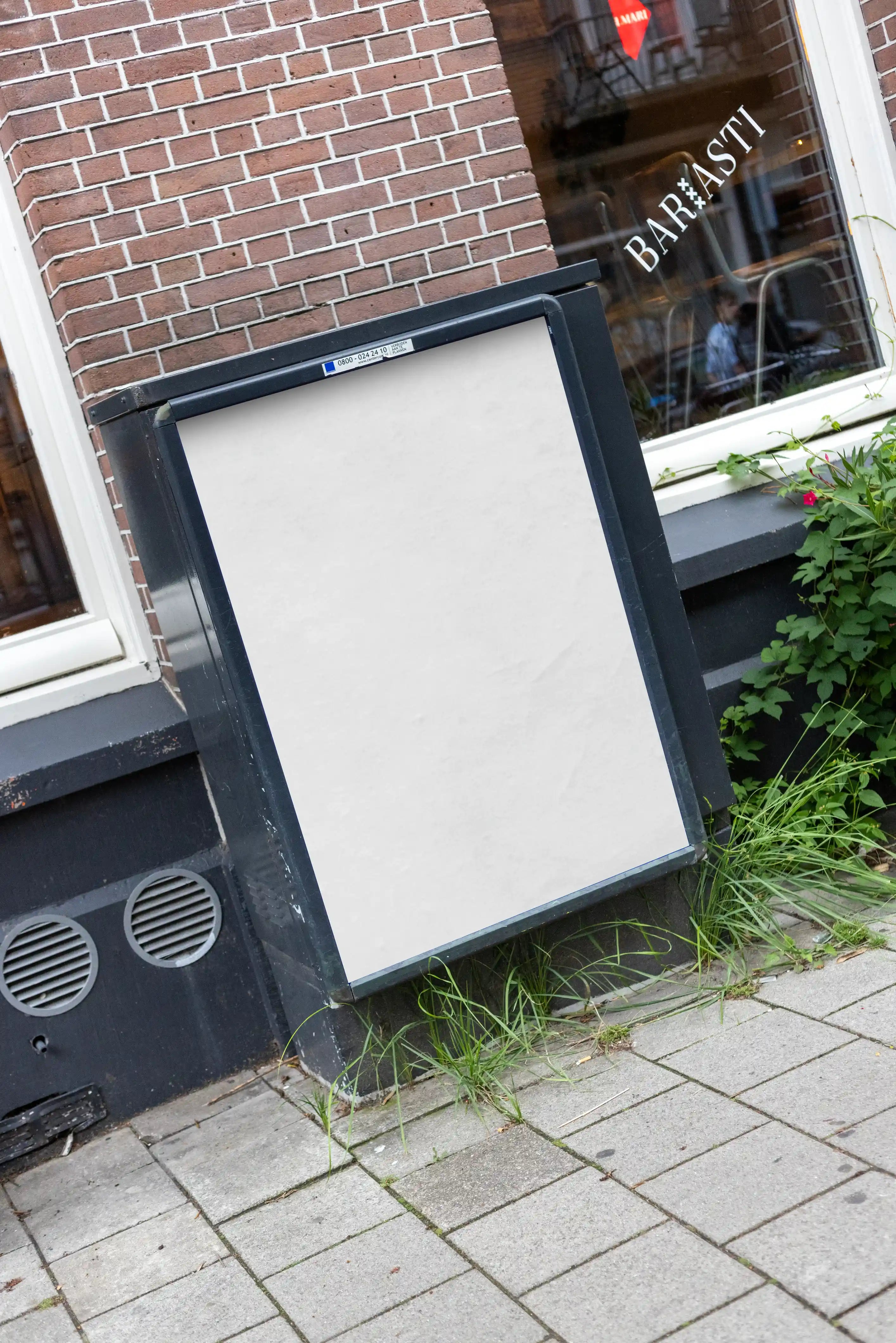Blank background Amsterdam De Pijp A-board poster mockup in DIN format positioned on a sidewalk outside a brick café building in Amsterdam, Netherlands.