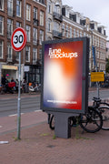 Amsterdam De Pijp city light poster mockup in a realistic urban street environment with bicycles, tram tracks and Dutch architecture in Amsterdam, Netherlands.