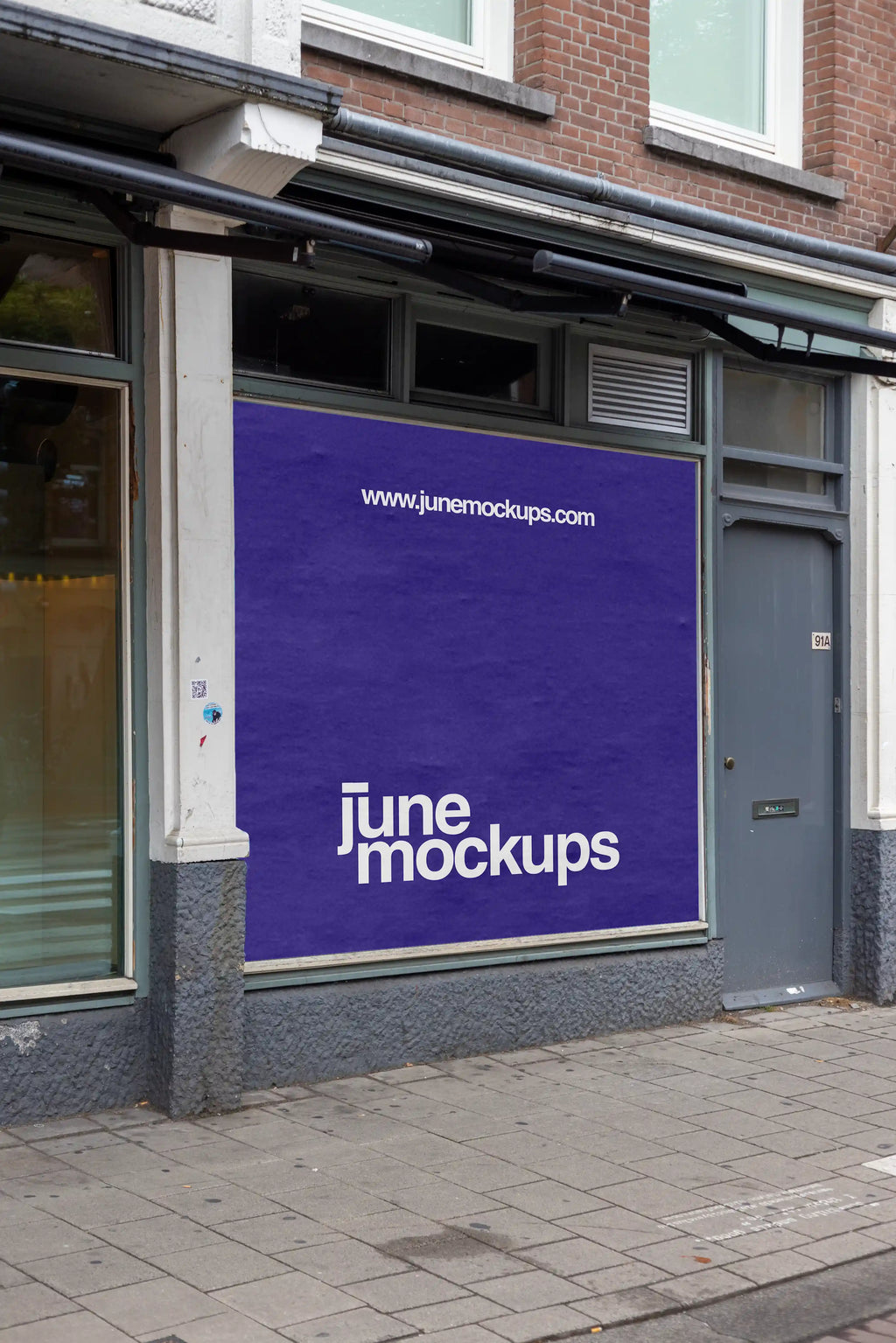 Large square storefront poster mockup in Amsterdam De Pijp featuring a realistic urban shop window facade with brick architecture, high resolution PSD template for branding and advertising presentations.