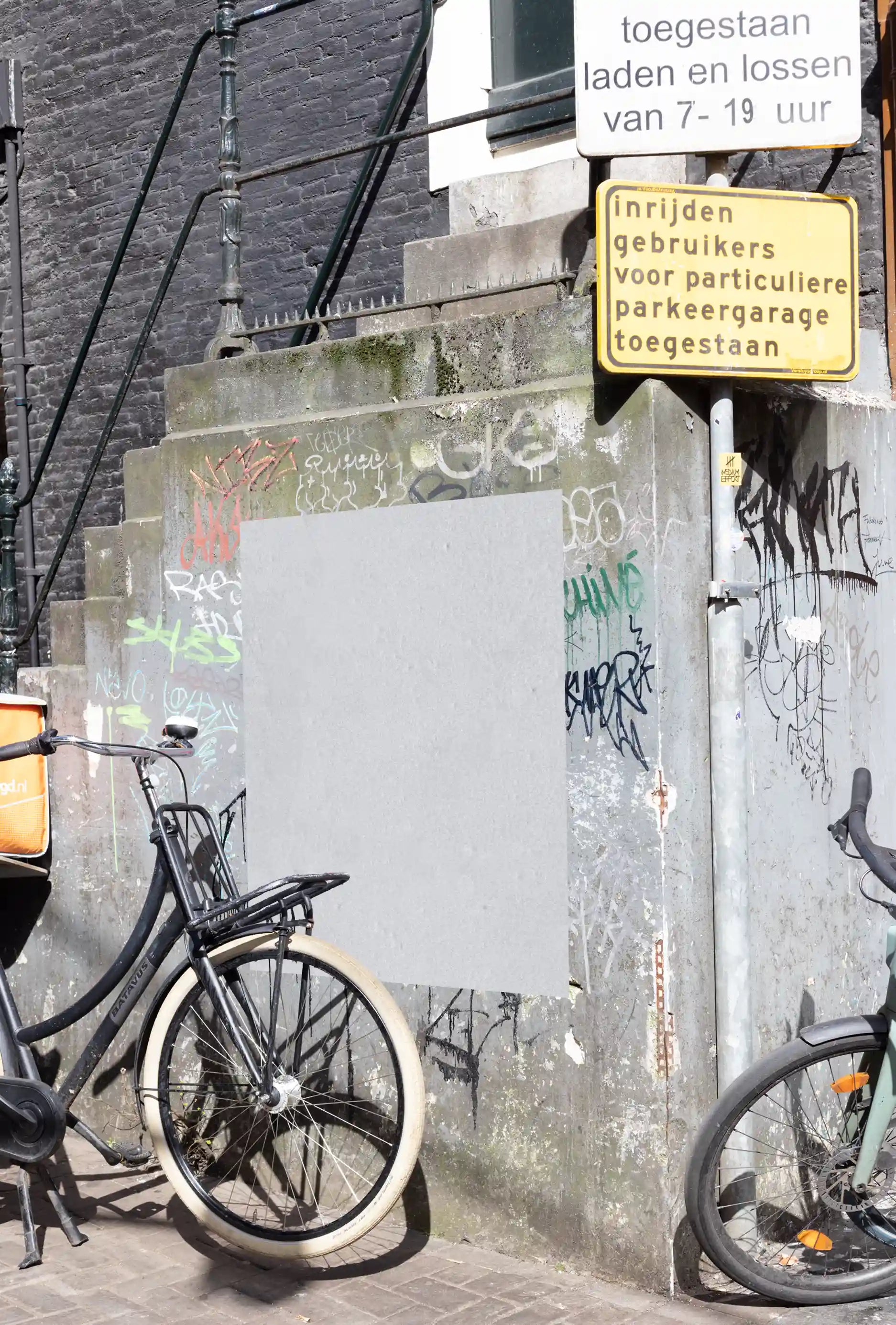 Amsterdam urban poster mockup at Leidseplein with bicycles and graffiti-covered wall.