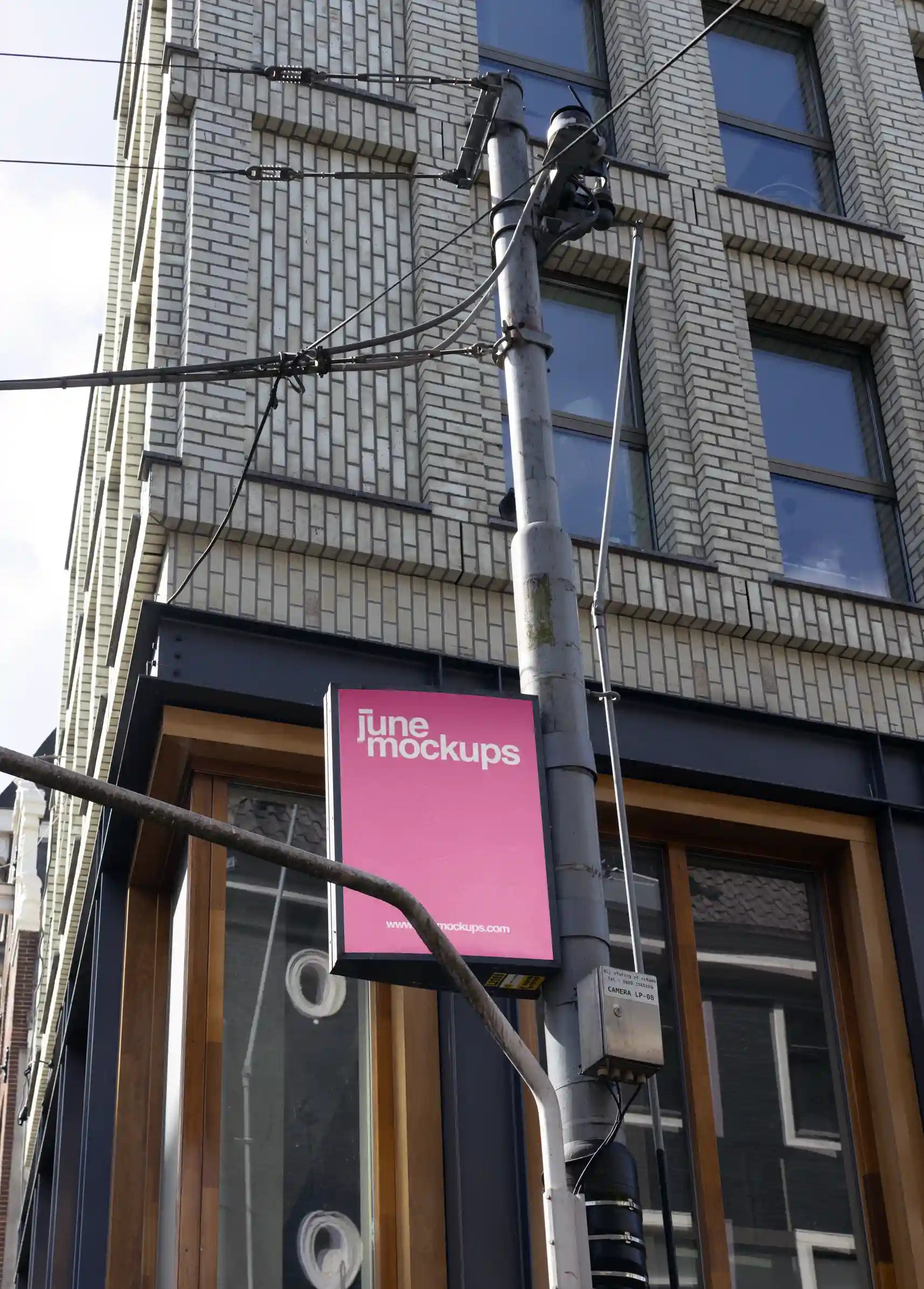 Amsterdam urban street mockup at Leidseplein with pink vertical sign on a street lamp
