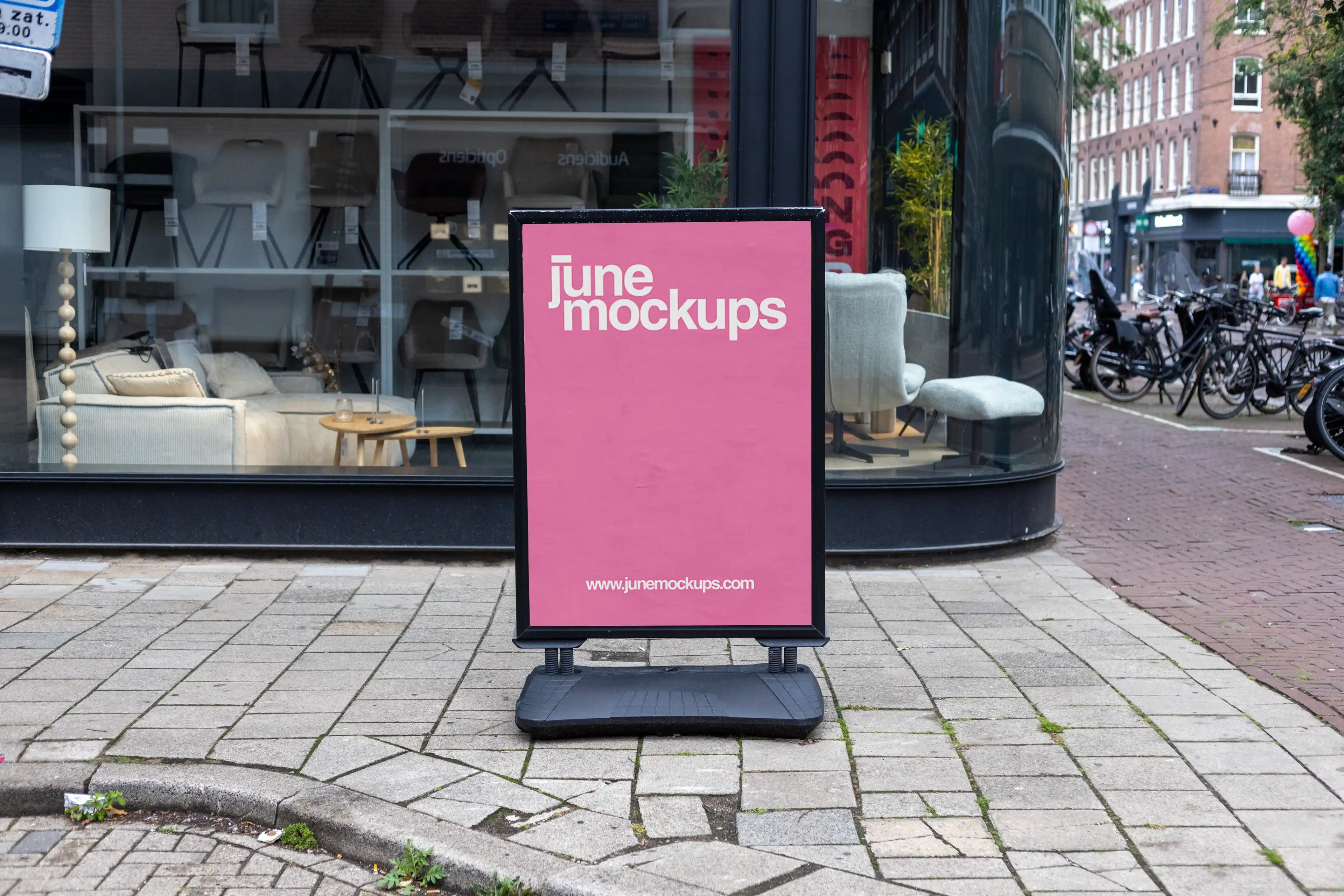 Poster mockup in Amsterdam Side Walk in front of a Store with authentic urban street setting, realistic illuminated display for professional branding and outdoor advertising presentations.