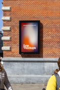 Amsterdam City Light Mockup mounted on red brick wall of Schouwburg Theater.