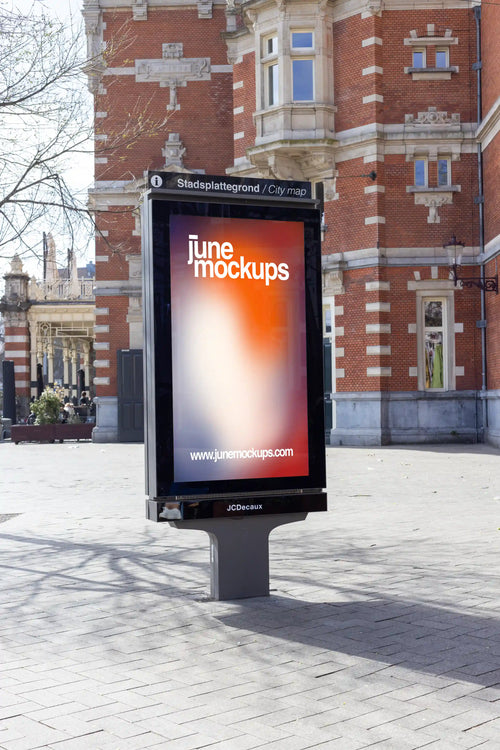 Amsterdam city light poster mockup in front of Schouwburg Theater with red brick facade.