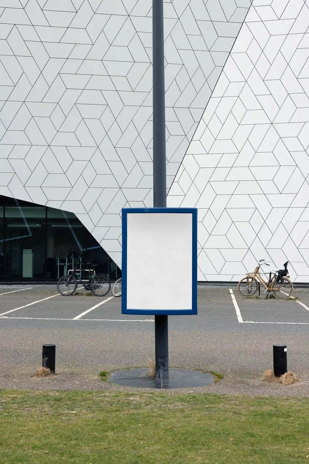 Street pole poster mockup near Eye Filmmuseum in Amsterdam with geometric modern building facade, ideal for outdoor advertising design.