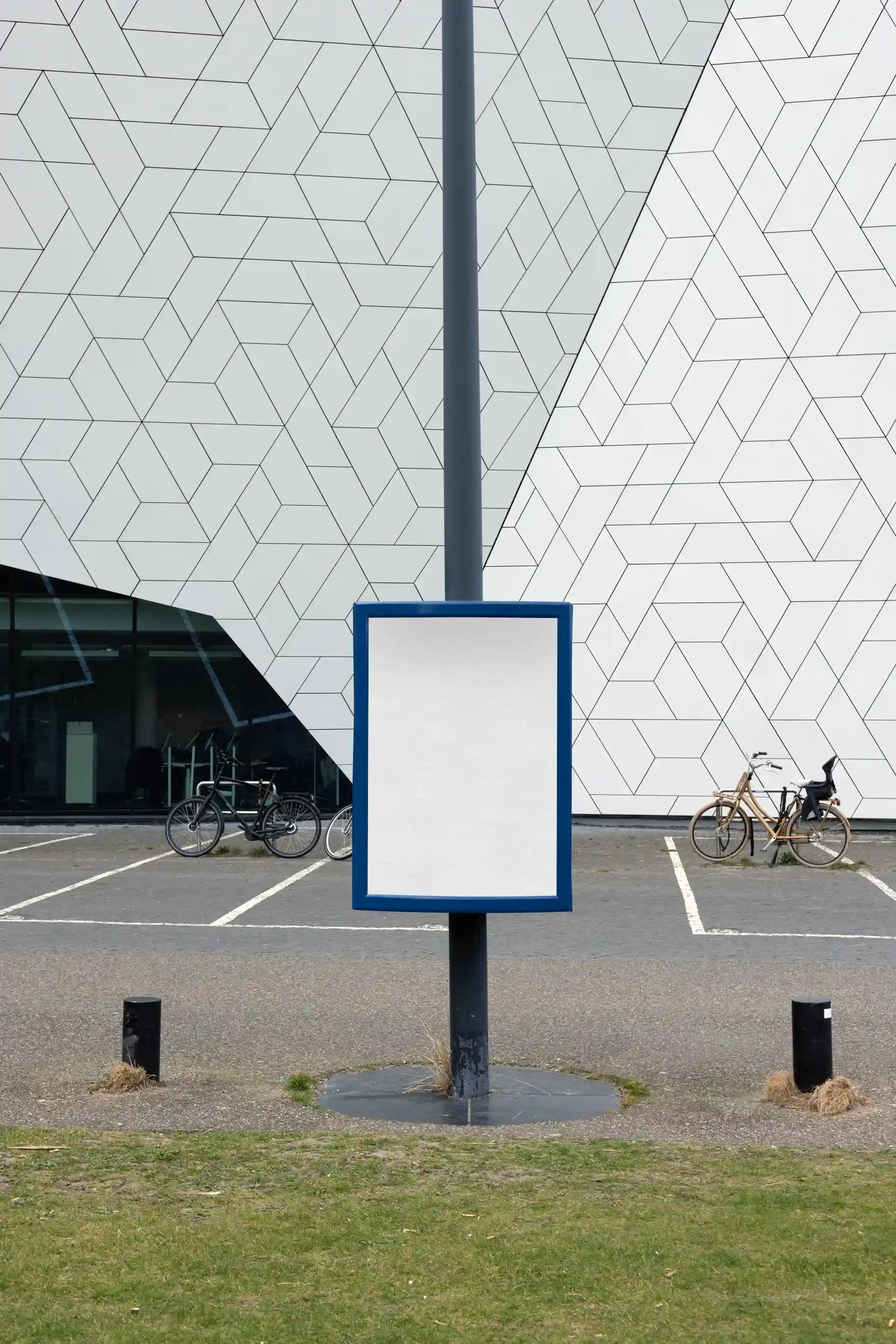 Street pole poster mockup near Eye Filmmuseum in Amsterdam with geometric modern building facade, ideal for outdoor advertising design.