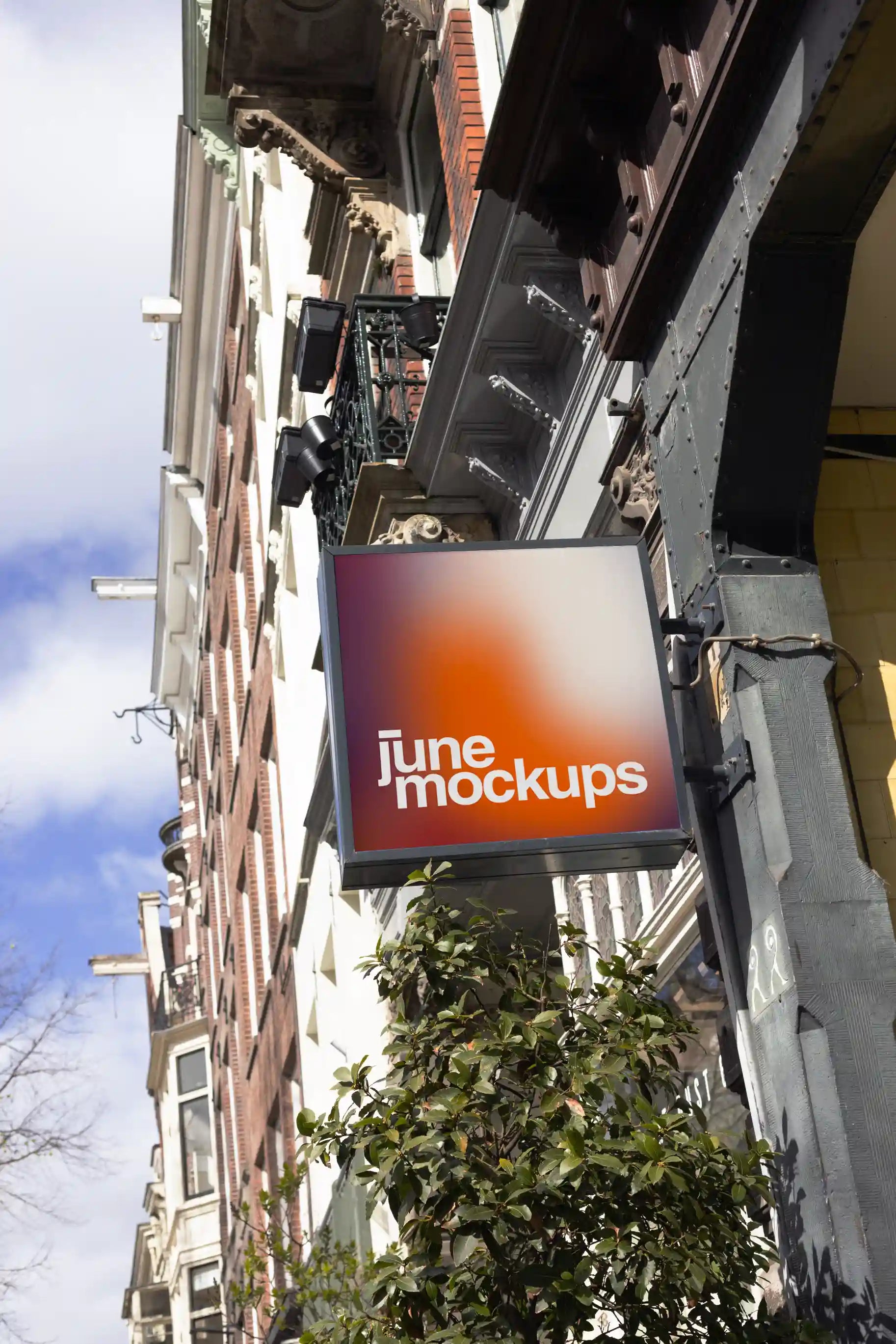 Amsterdam urban street logo mockup with vertical shop sign on traditional brick building facade.