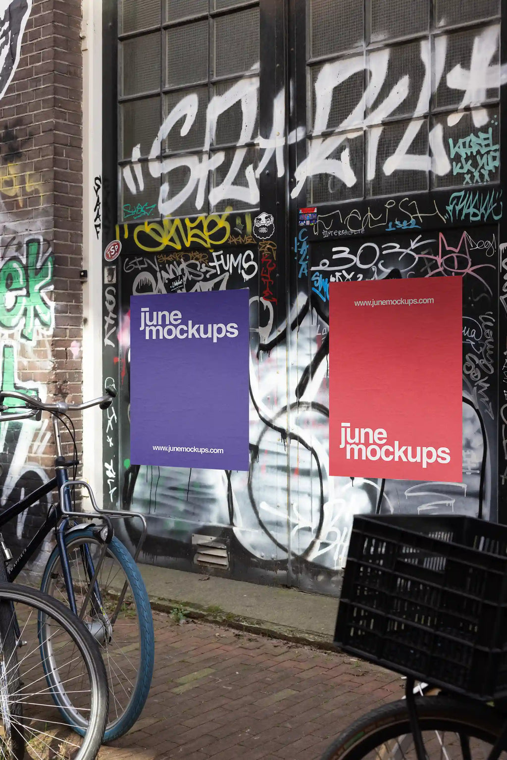 Amsterdam urban street mockup with two posters, red and purple, next to parked bicycles in front of a graffiti door.