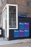 Amsterdam urban street poster mockup at Eerste Weteringdwarsstraat, colorful posters displayed on a black-painted brick wall