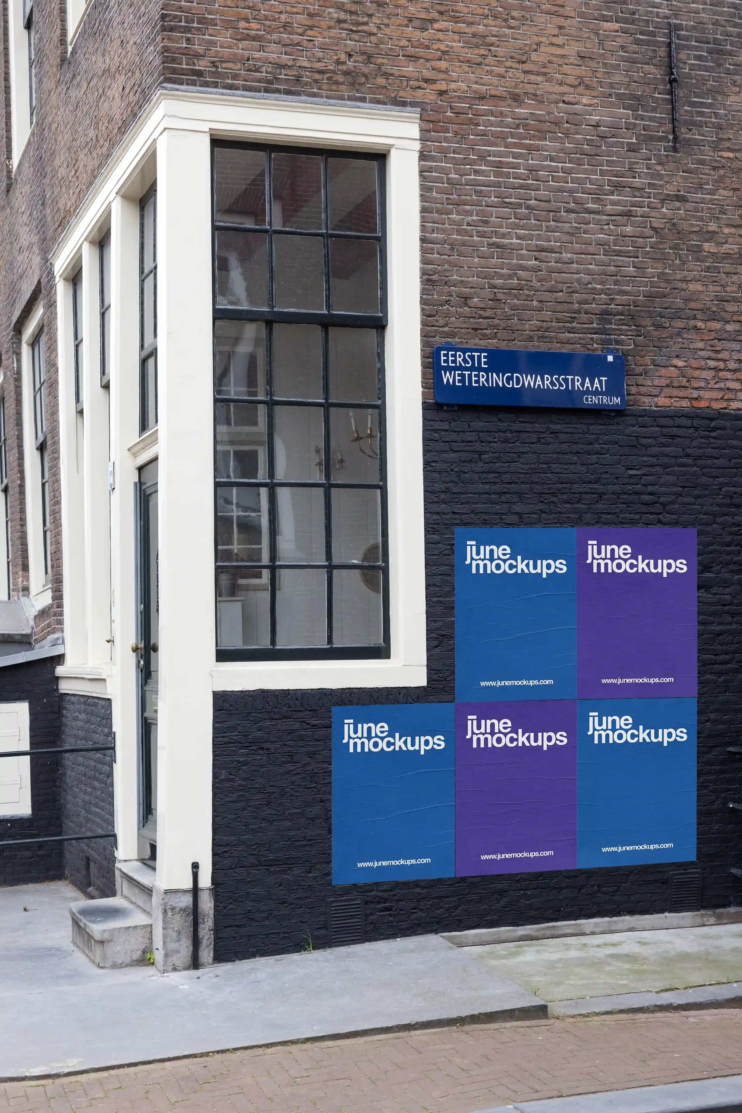 Amsterdam urban street poster mockup at Eerste Weteringdwarsstraat, colorful posters displayed on a black-painted brick wall
