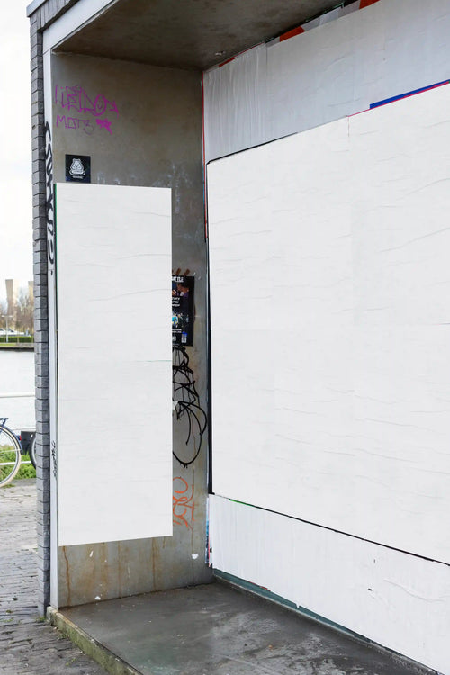 Urban street poster mockups in Amsterdam on the waterfront side, featuring alternating white posters