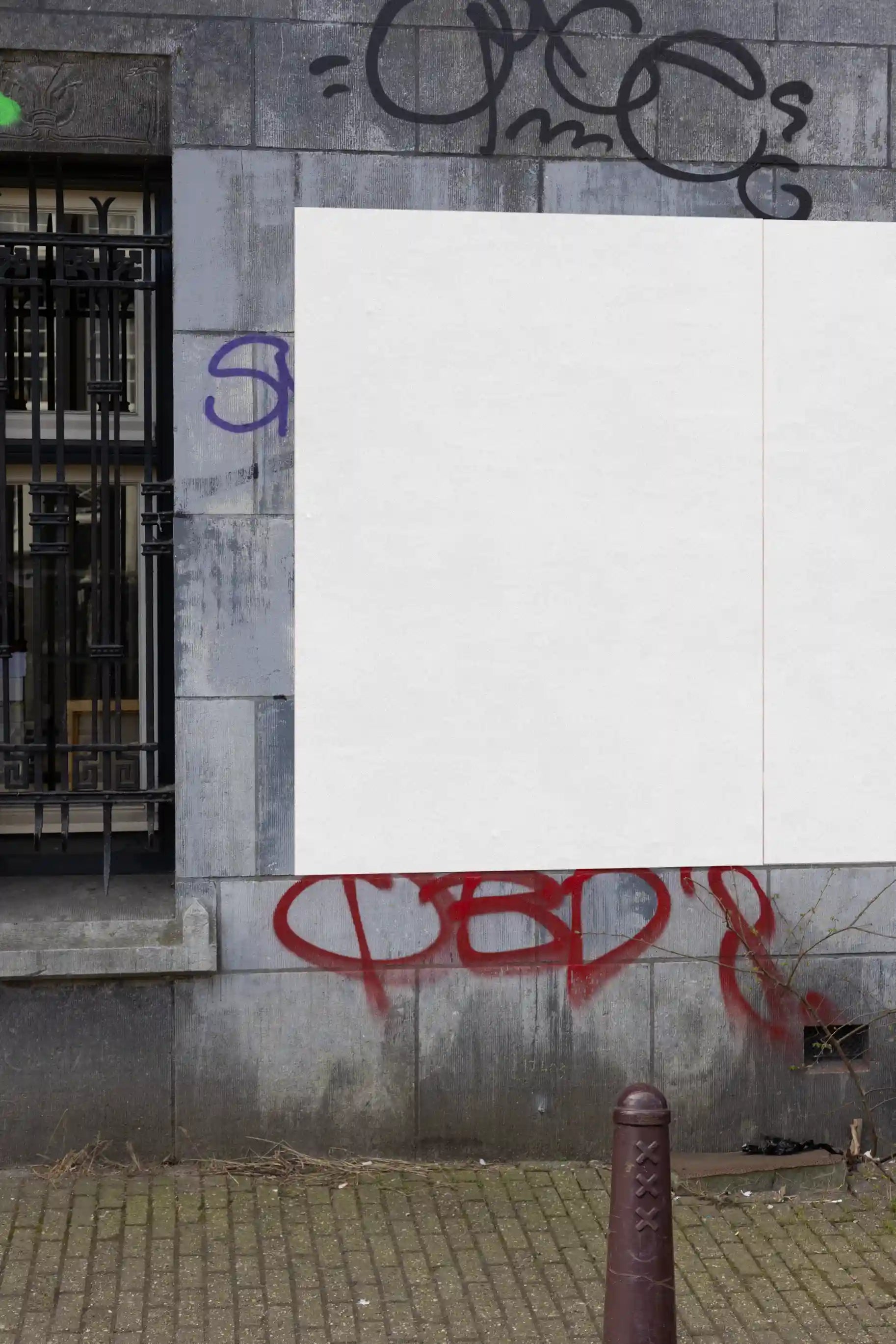 Amsterdam urban street mockup with two colorful posters, red and orange, on a graffiti-covered wall.