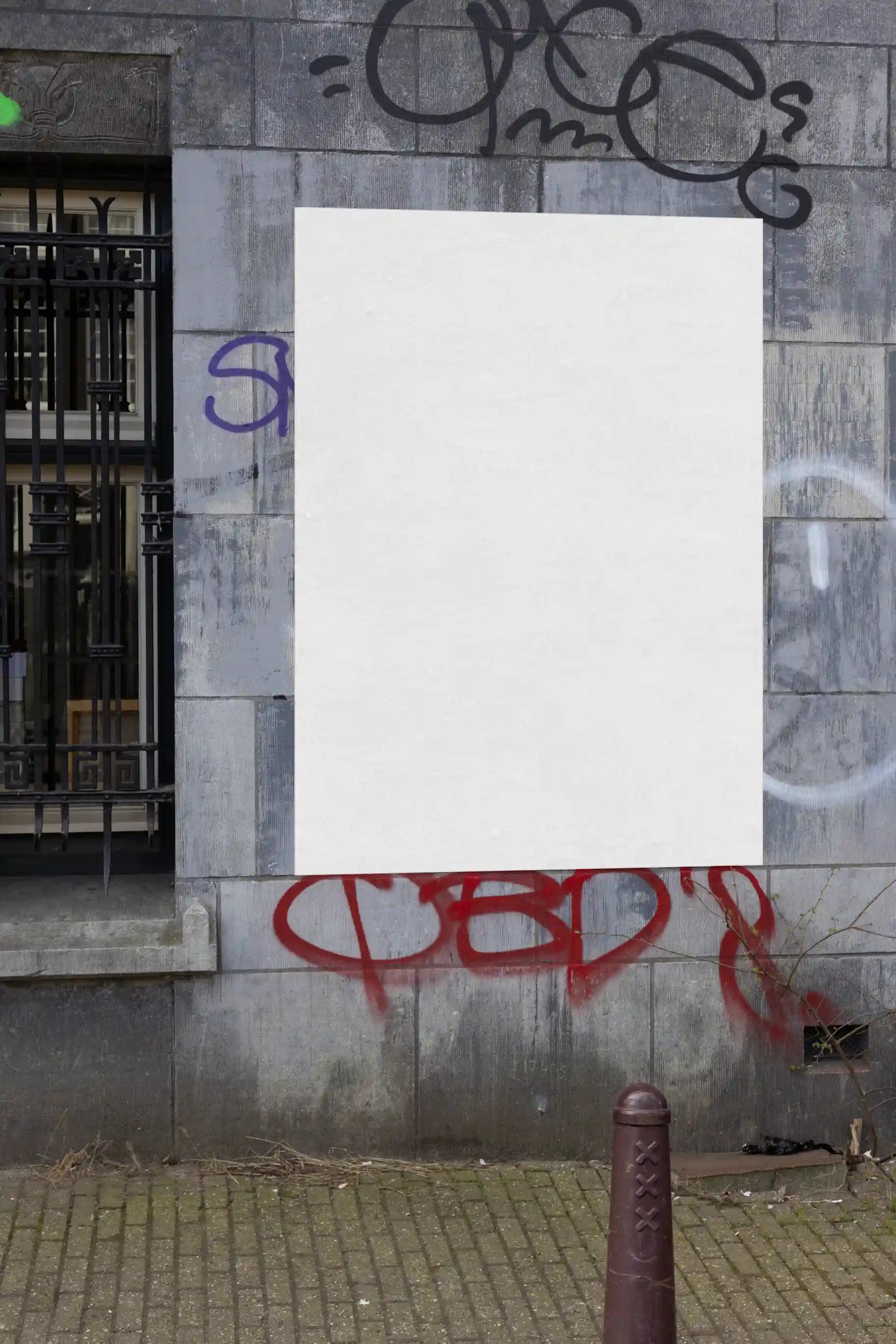 Amsterdam urban street mockup with single red poster on a grey stone wall with graffiti.
