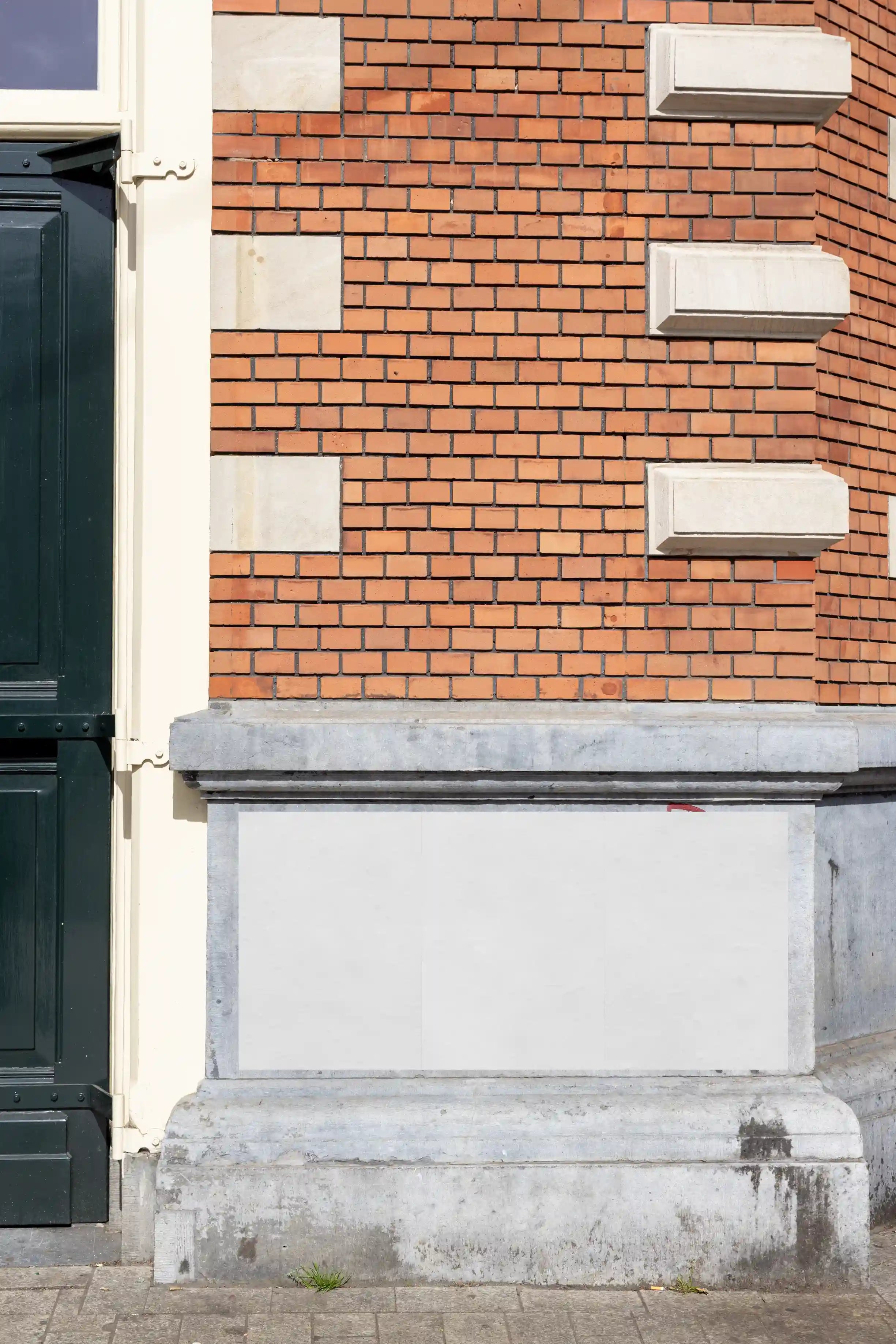 Amsterdam urban street poster mockup on a classic brick façade with three posters in orange and purple, perfect for realistic design presentations