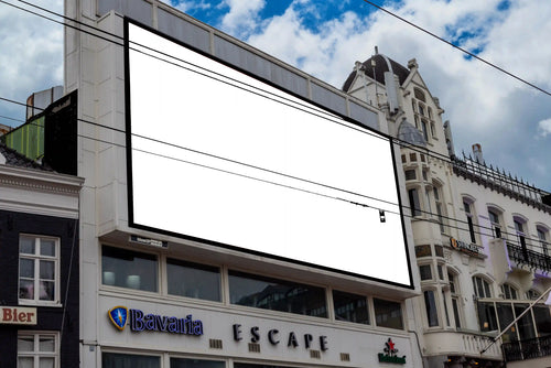 Large billboard mockup at Rembrandtplein in Amsterdam, located above Escape Club with red poster design.