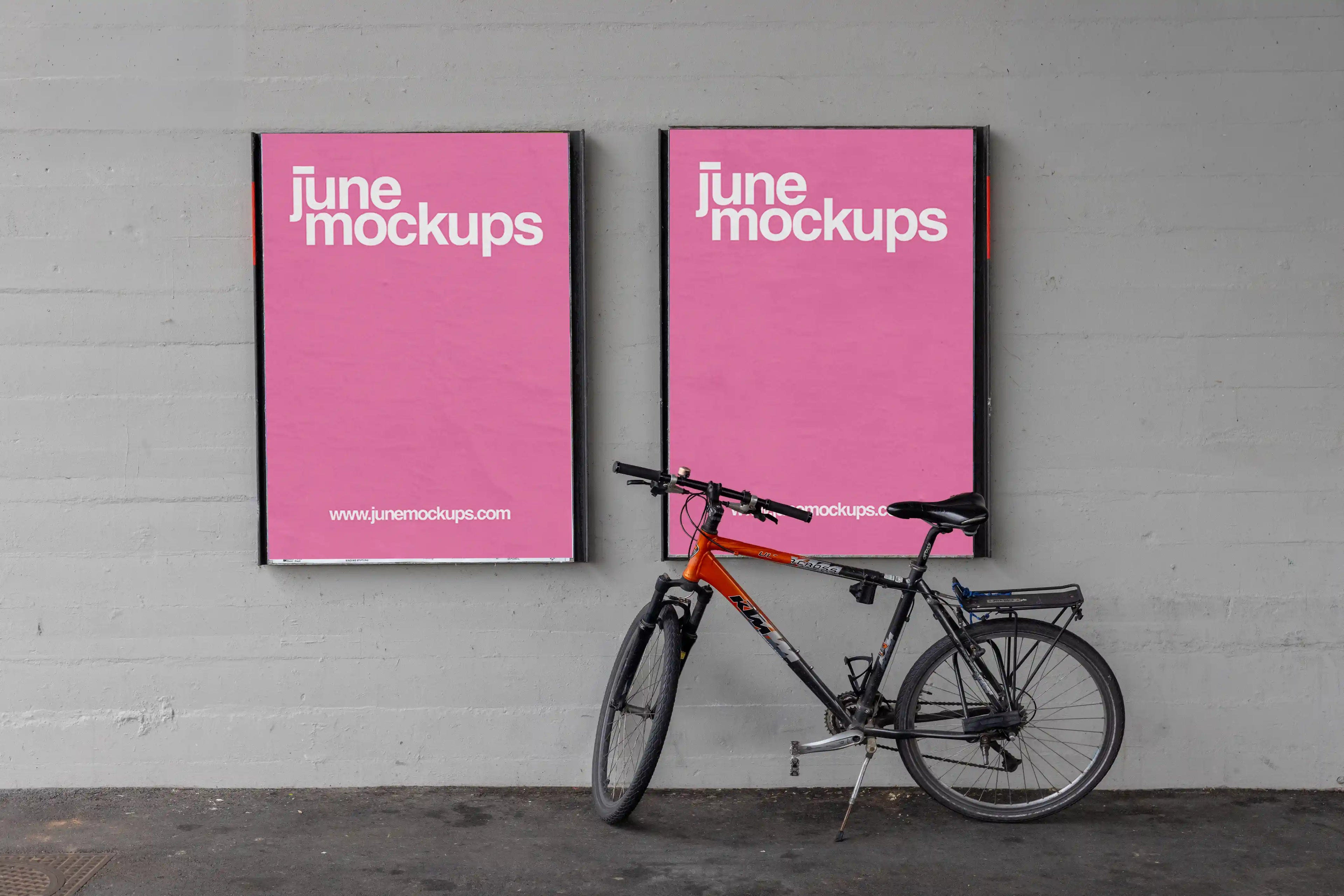 Two pink DIN poster mockups mounted side by side on a grey concrete wall under a bridge in Basel. A black and orange bicycle leans in front of the right poster, with realistic paper texture, soft shadows, dark floor details and an urban underpass atmosphere.
