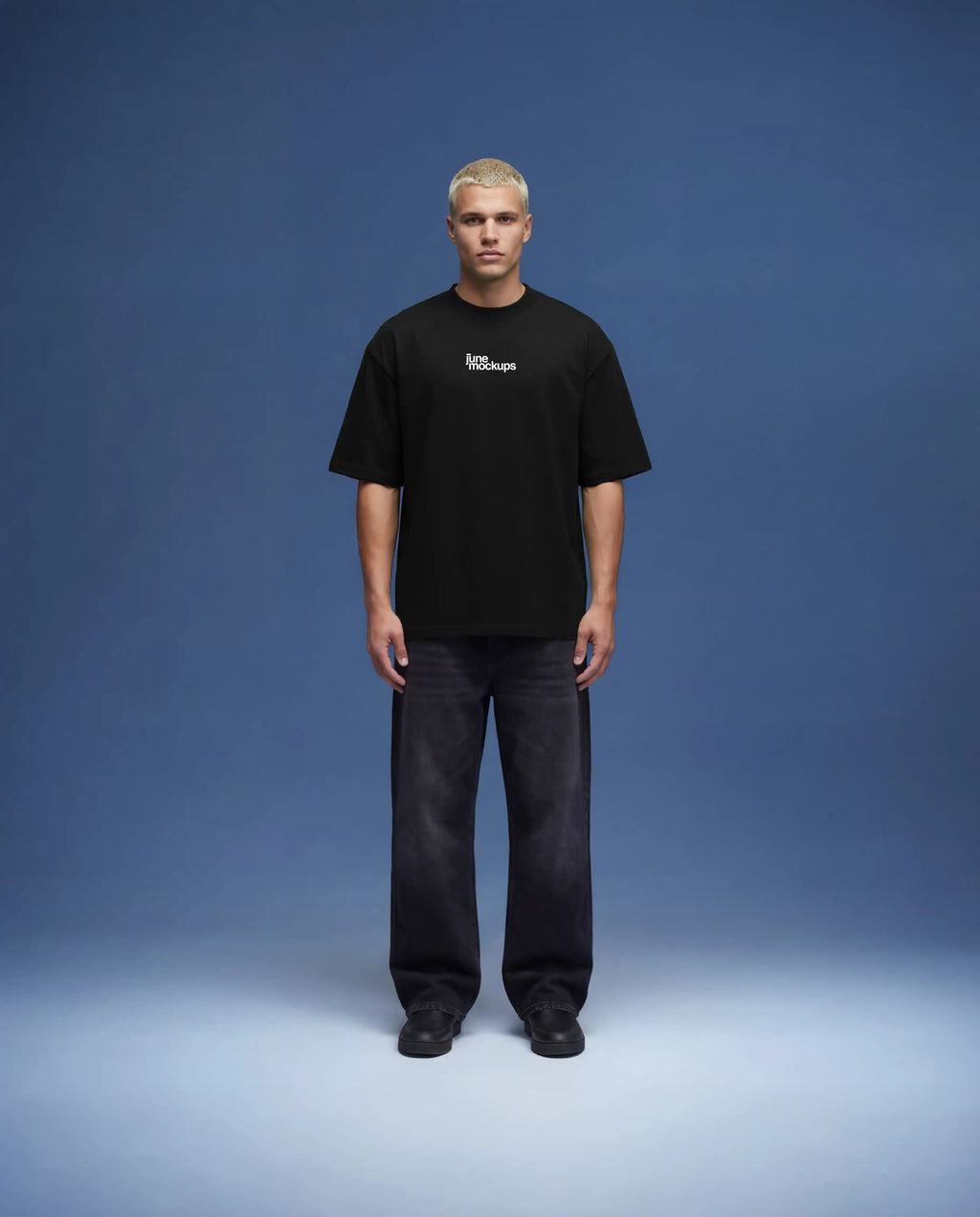 Full body black oversized t-shirt mockup front view worn by male model with relaxed fit, realistic fabric drape and natural shadows, clean studio setup with blue background, high resolution apparel mockup for fashion brands, streetwear collections and e-commerce presentation.