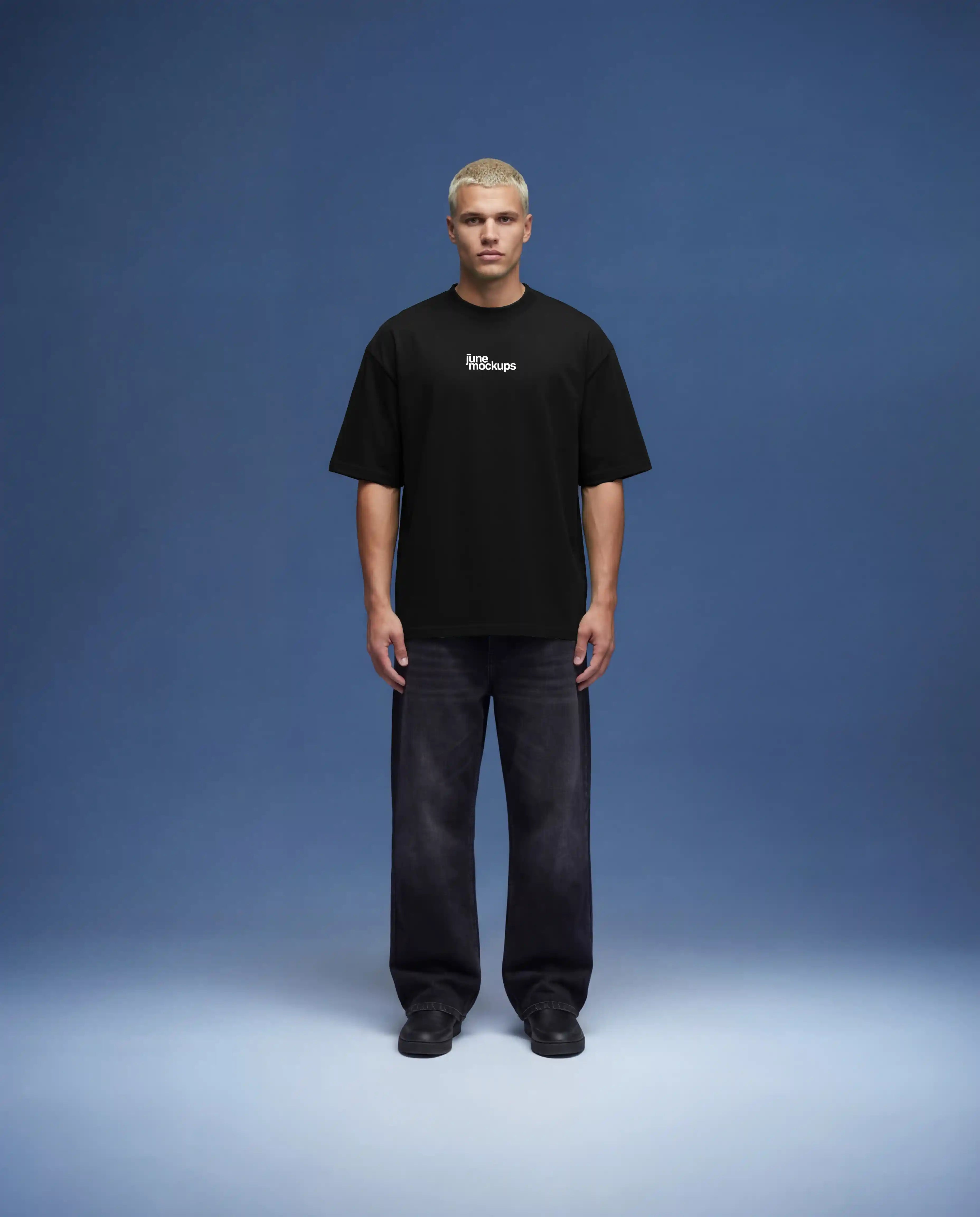 Full body black oversized t-shirt mockup front view worn by male model with relaxed fit, realistic fabric drape and natural shadows, clean studio setup with blue background, high resolution apparel mockup for fashion brands, streetwear collections and e-commerce presentation.