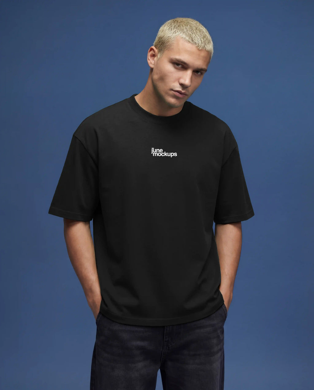 Black oversized t-shirt mockup front close-up with small centered chest logo, detailed cotton fabric texture, natural wrinkles and soft shadows, studio lighting on blue background, perfect for logo branding, minimalist apparel design and high resolution mockup use.