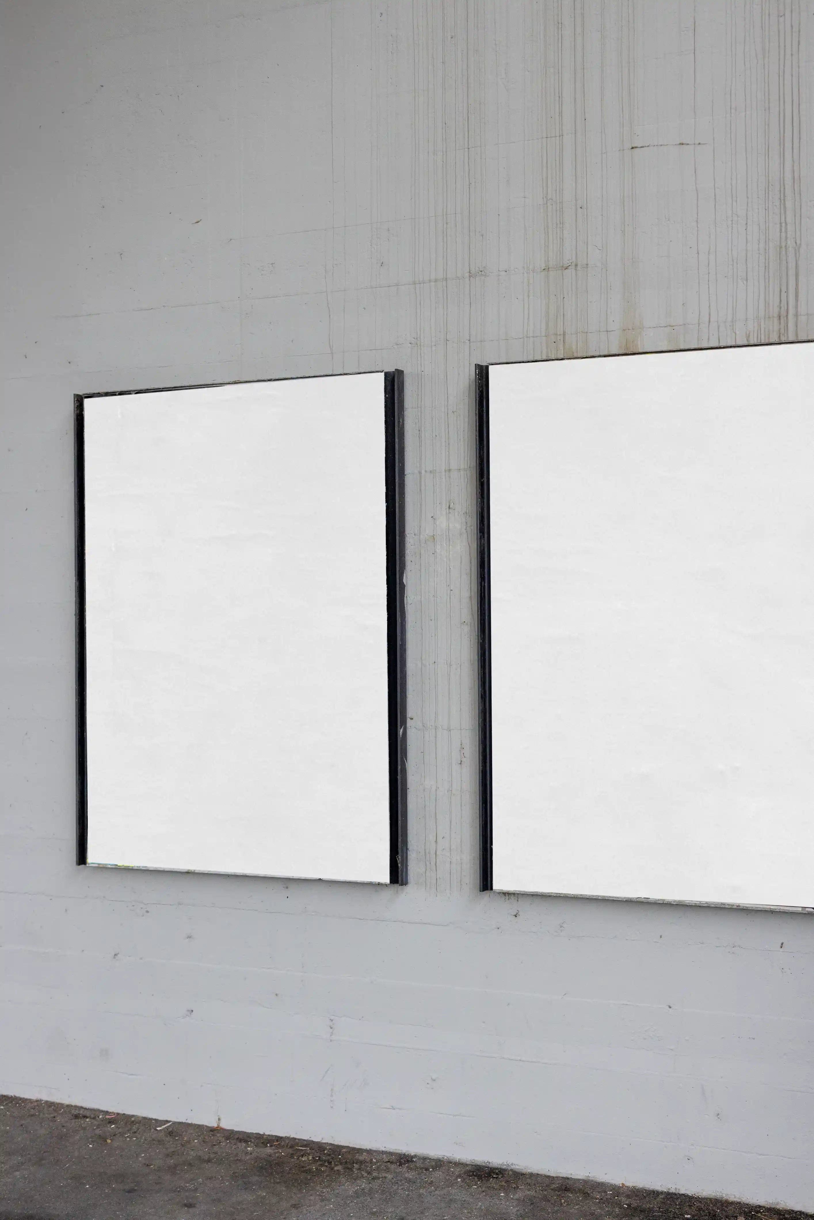Blank framed out of home poster mockup duo in Basel with two white editable poster displays on a concrete wall, realistic outdoor advertising setting, natural wall texture and clean urban composition, perfect for poster designs, brand campaigns, event artwork, music posters and street advertising previews.