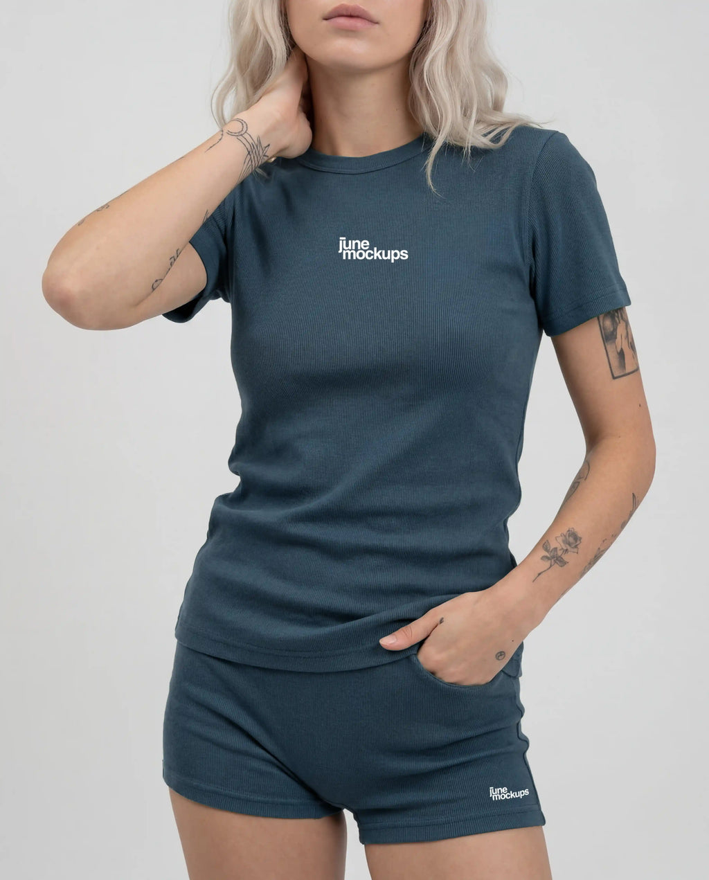 Realistic blue ribbed streetwear apparel mockup showing a female model wearing a t-shirt and shorts set with small front logo placement, ideal for fashion branding, activewear visuals, merch designs and clothing brand presentations.