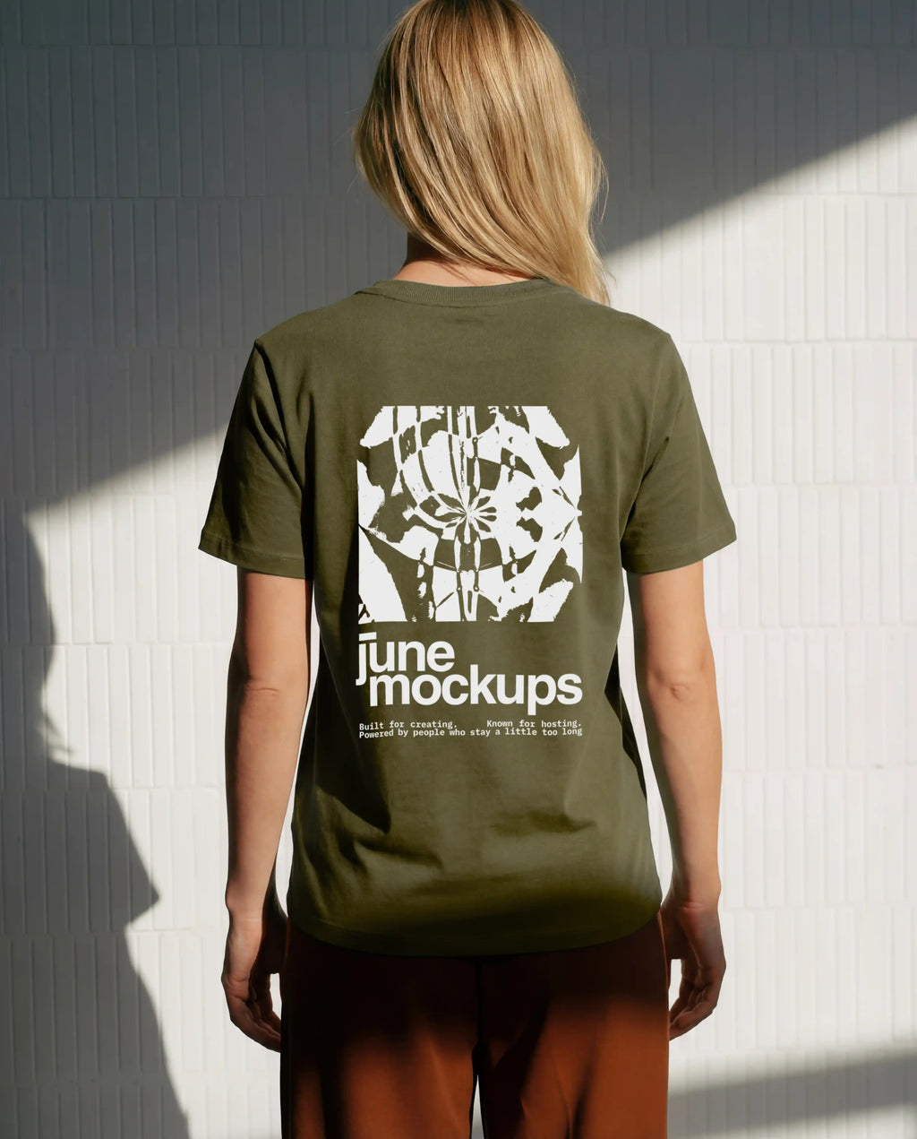 Female olive green t-shirt mockup with large back print design, photographed in natural sunlight with realistic shadows and fabric folds, ideal for streetwear brands, fashion collections, merch designs and apparel branding visuals.