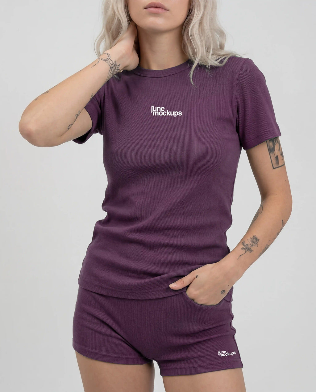 Female purple ribbed streetwear t-shirt and shorts mockup with editable front logo placement, realistic fabric folds and clean studio background, perfect for clothing brands, fashion campaigns, merch collections and apparel mockup presentations.