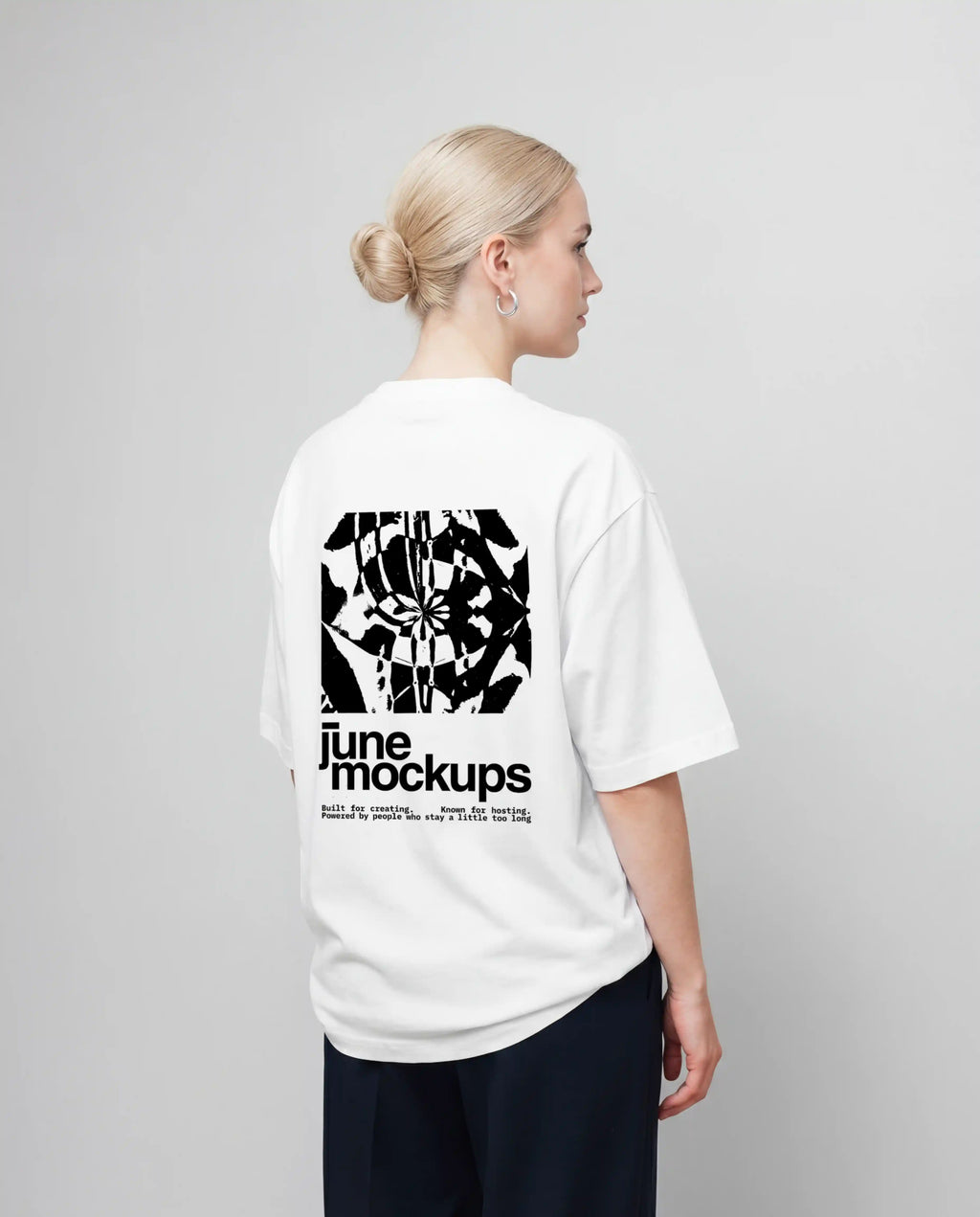 Female white oversized t-shirt mockup with large black back print design, clean studio background and natural fabric folds, perfect for apparel branding, streetwear collections, fashion campaigns, merch designs and clothing label presentations.