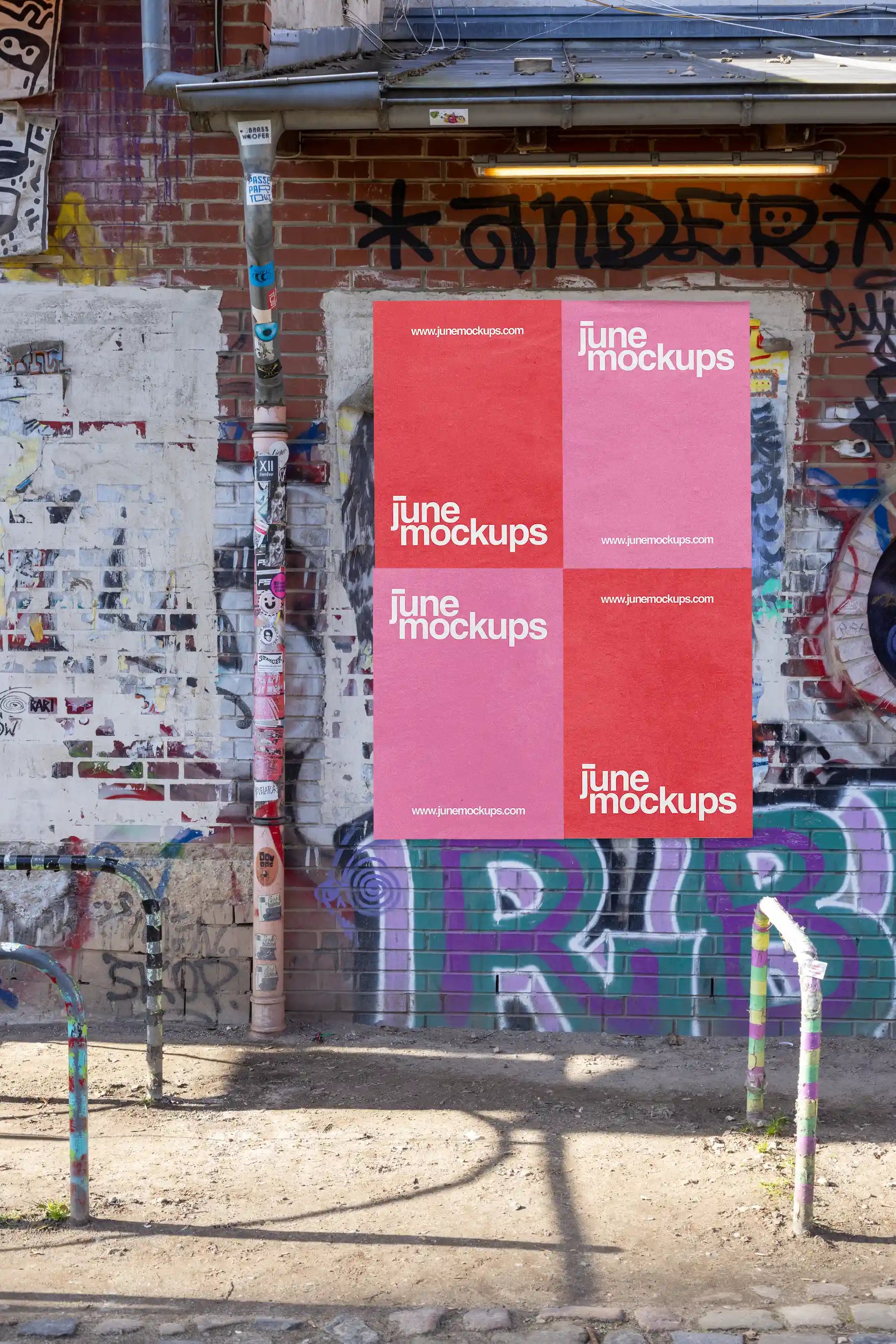 Urban street poster mockup on a textured brick wall with graffiti, stickers, and natural sunlight in Hannover. This high-resolution PSD template is ideal for street art, cultural event promotions, and creative outdoor branding visuals.