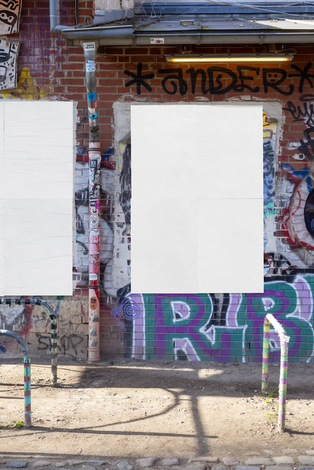 Blank double-poster wall mockup with a textured urban graffiti background. Ideal for inserting two vertical poster designs with realistic light, shadow, and paper details for professional street campaign visuals.