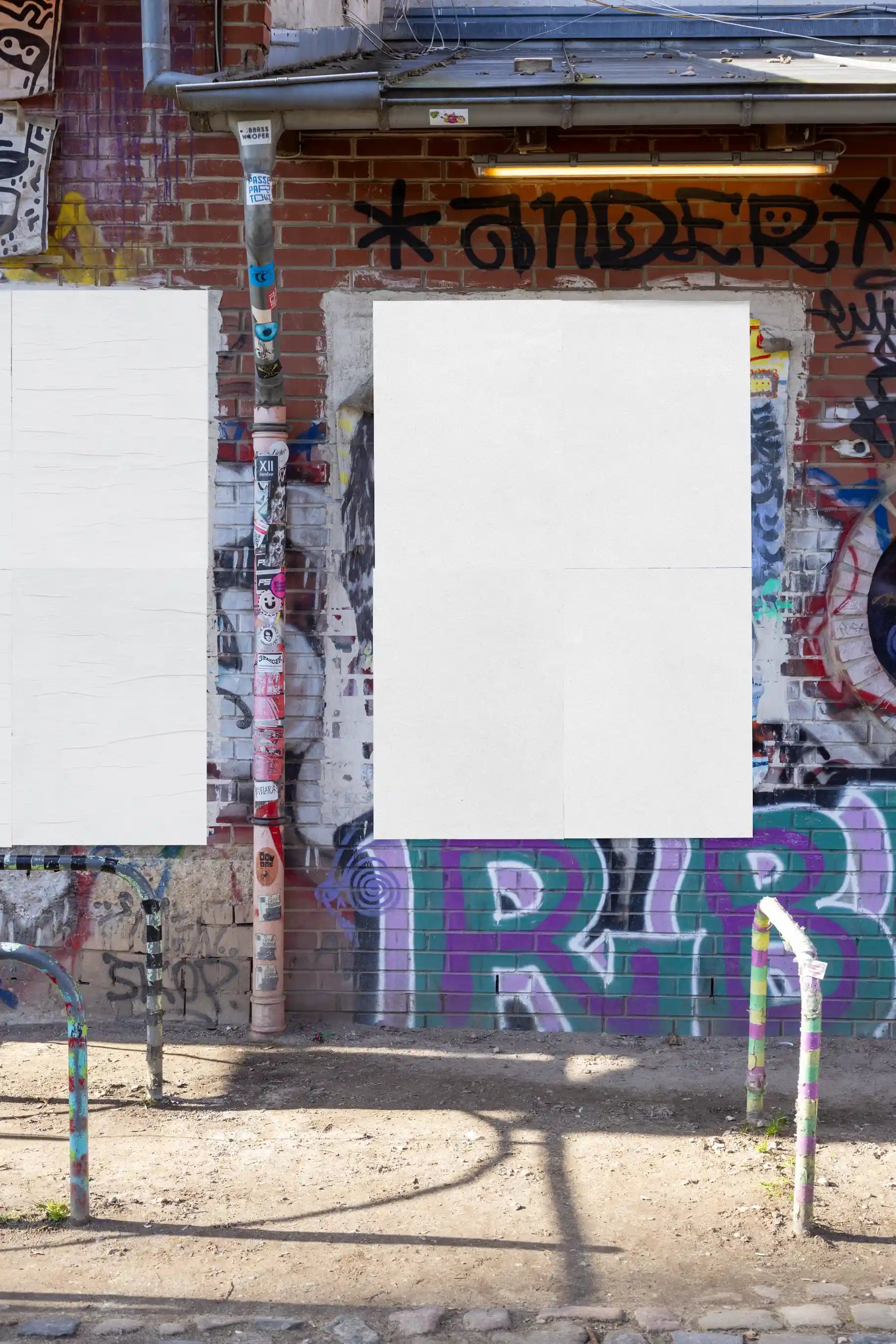 Blank double-poster wall mockup with a textured urban graffiti background. Ideal for inserting two vertical poster designs with realistic light, shadow, and paper details for professional street campaign visuals.