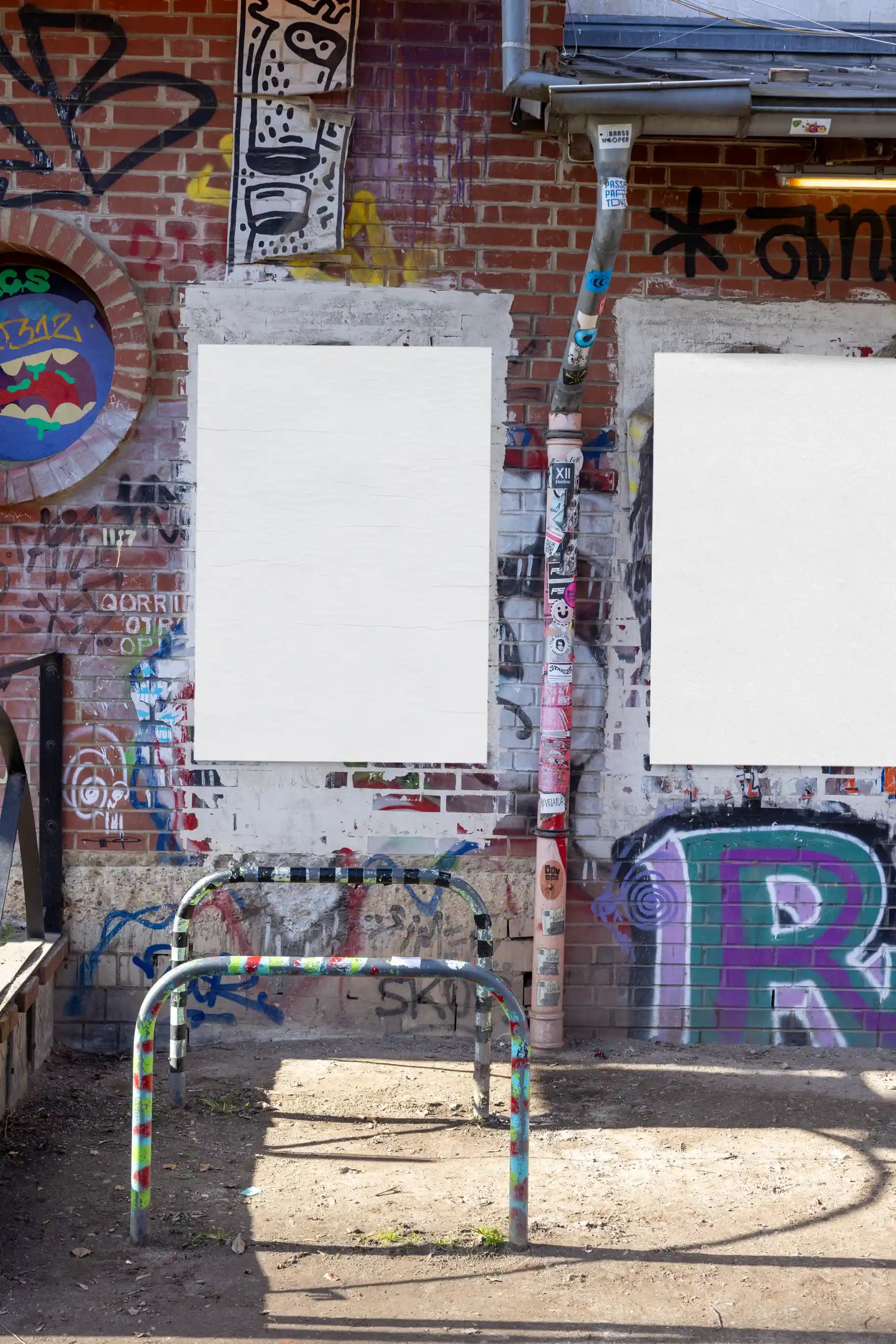 Single-poster mockup with clean paper texture on a graffiti-covered wall. Perfect for showcasing creative poster designs in a raw urban street context.