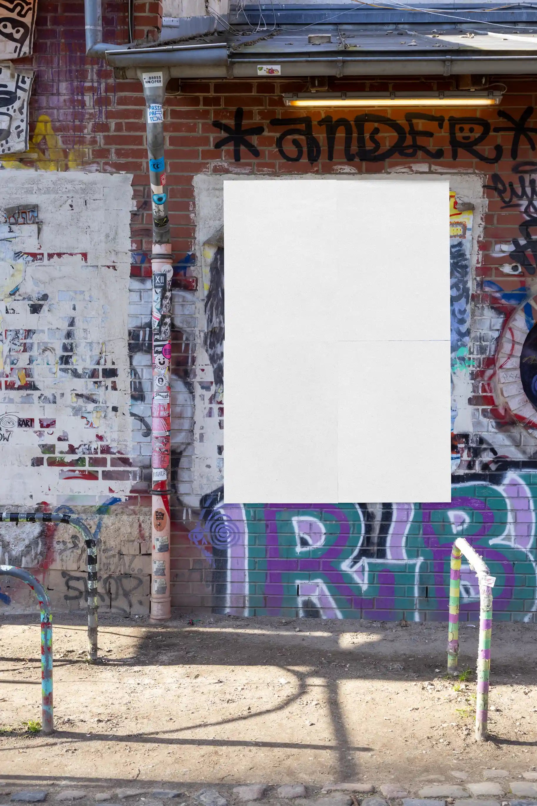 Street poster mockup template with realistic brick wall texture and urban graffiti background. Designed for showcasing poster artwork, advertising layouts, or design presentations in authentic outdoor settings.