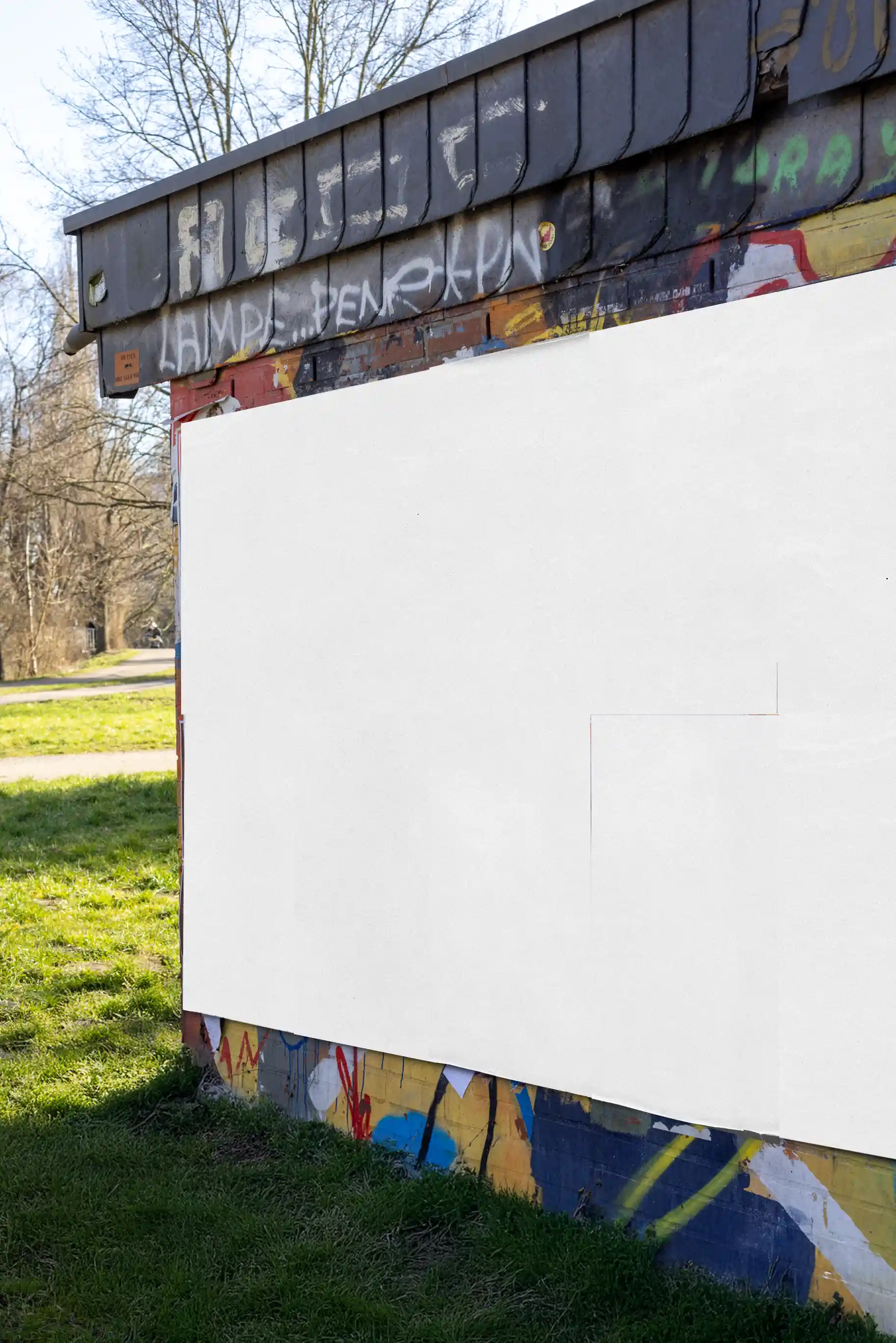 Blank urban wall mockup with a realistic street graffiti background. Ideal for inserting custom poster designs with authentic paper folds, sunlight reflections, and a textured outdoor surface for professional visual presentations.