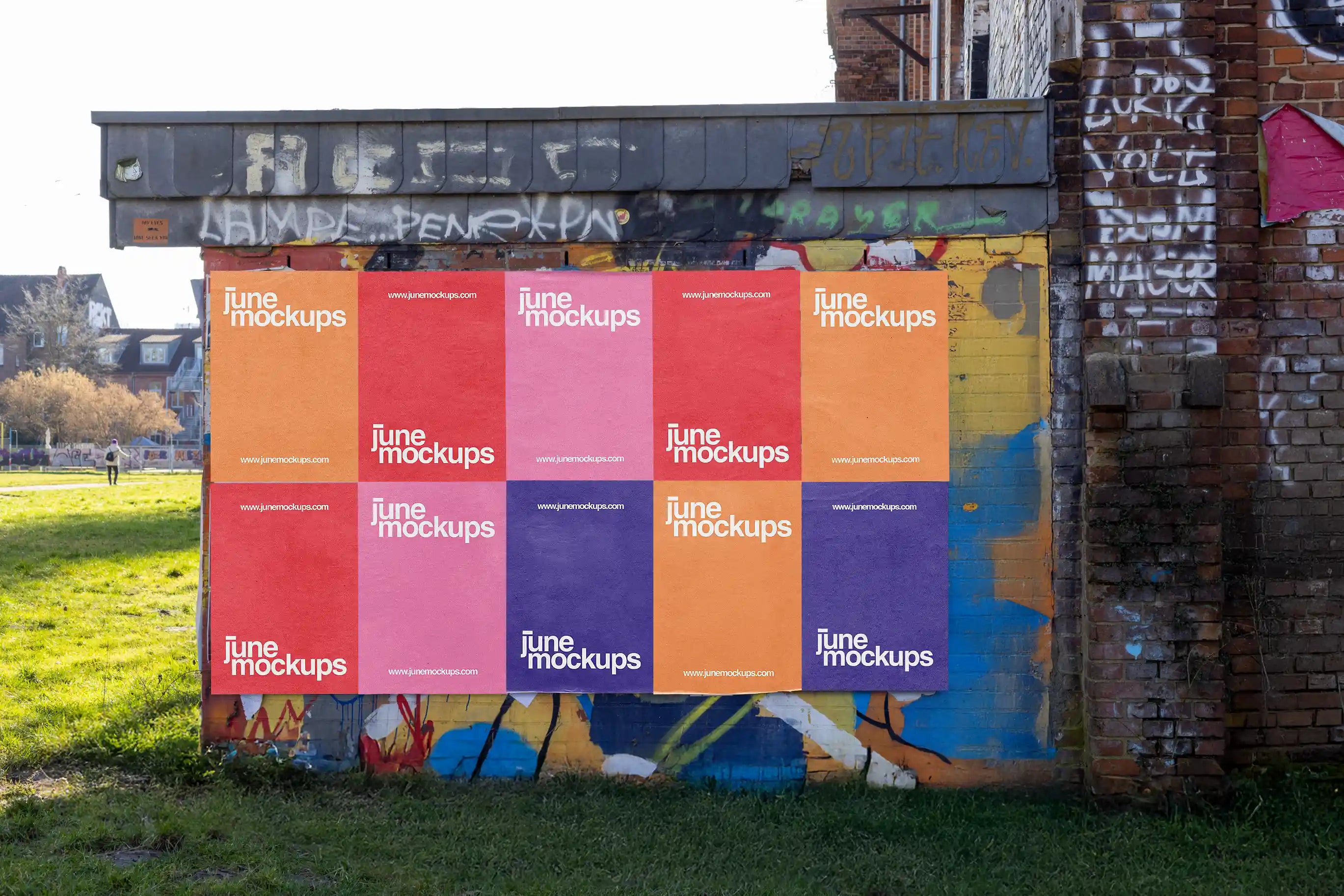 High-resolution urban wall mockup showing multiple colorful posters pasted on a graffiti-covered wall in Hanover. Natural daylight, shadow play, and paper seams create a vivid, realistic street design scene perfect for branding or art campaigns.