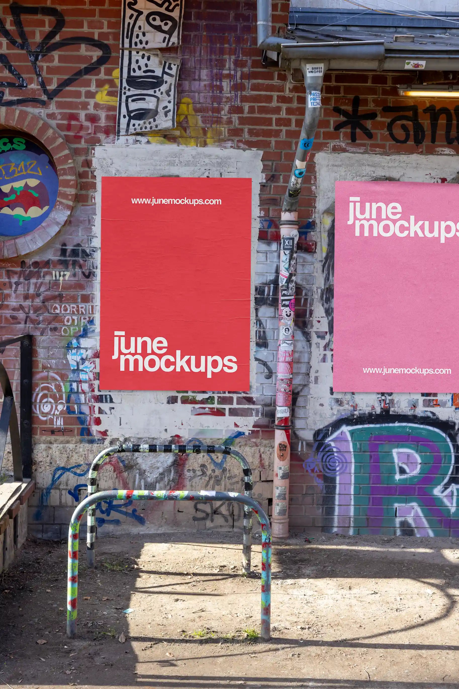 Single street poster mockup displayed on a brick wall with graffiti and stickers. Features natural sunlight, realistic shadows, and fine paper texture. Ideal for modern street art or cultural event design presentations.