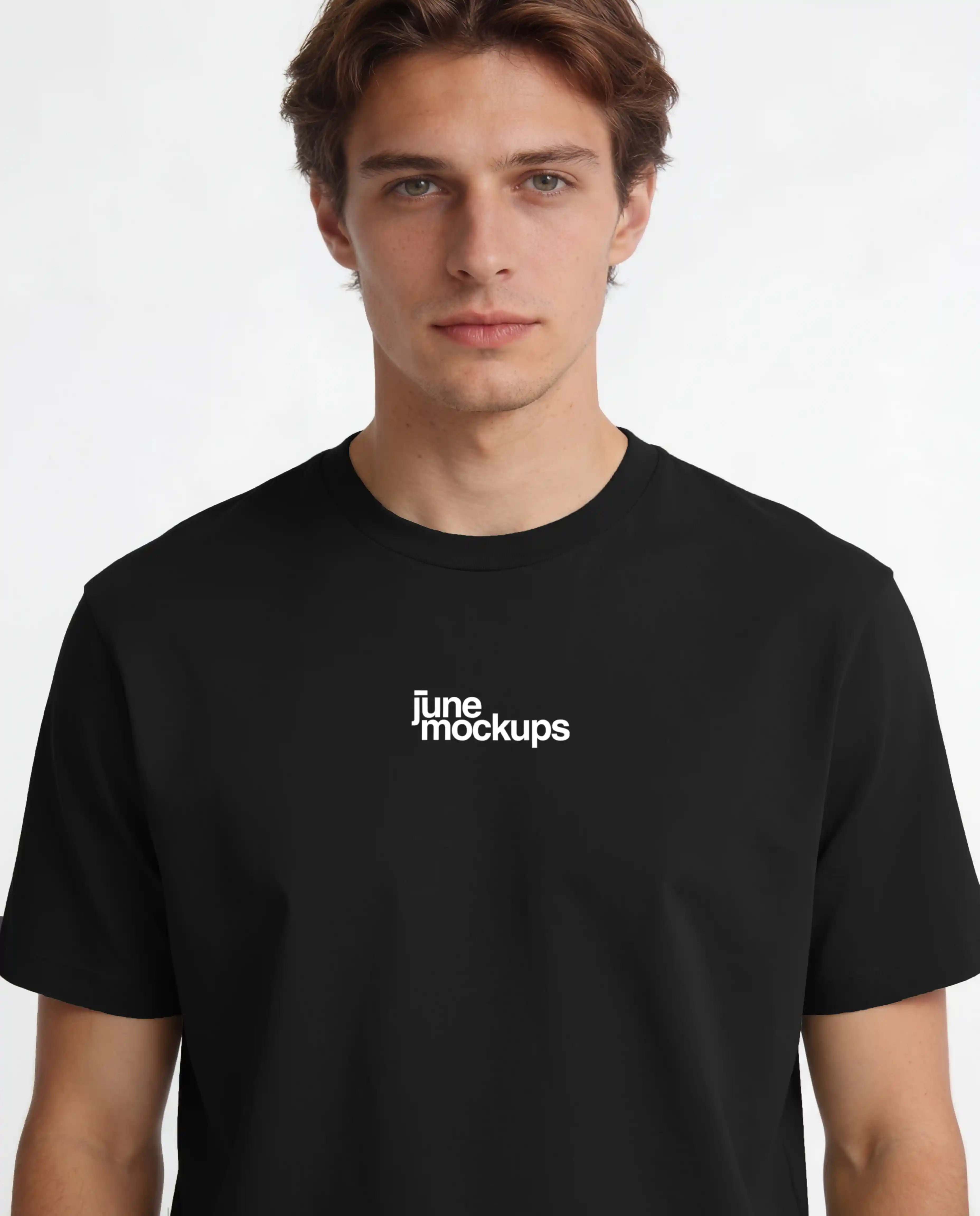 Close-up studio t-shirt mockup showing a male model wearing a black shirt with front logo print placement, realistic fabric texture and clean lighting, perfect for streetwear brands, logo mockups, apparel branding and merch design previews.