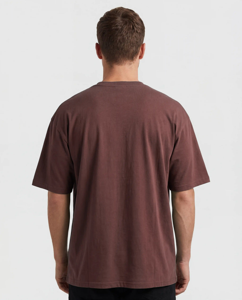 Male oversized t-shirt mockup from the back showing a blank editable shirt surface in brown, clean studio lighting and realistic fabric structure, ideal for back print designs, clothing brands, streetwear collections and apparel presentations.