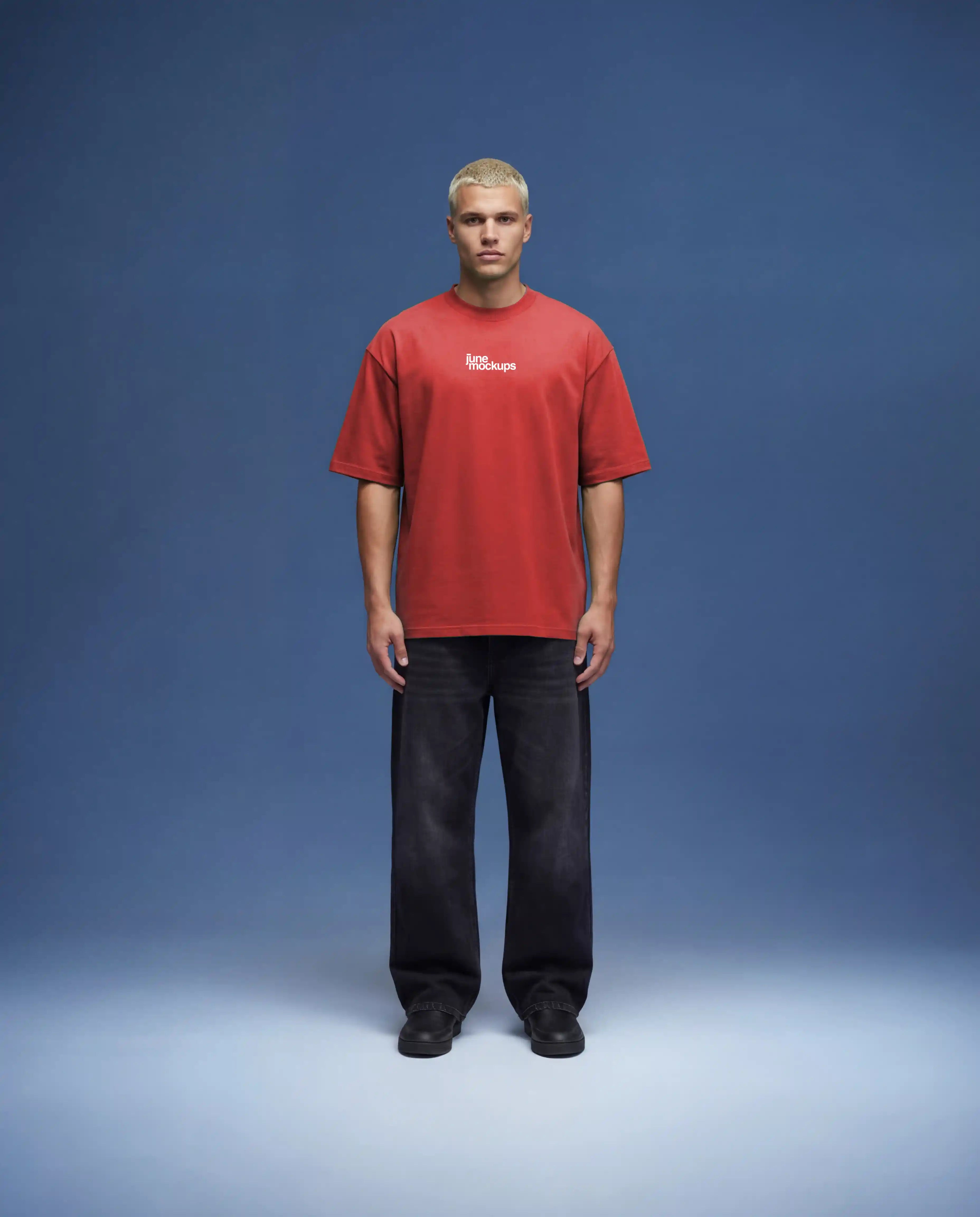 Full body red oversized t-shirt mockup front view with loose fit and natural fabric movement, worn by model in minimal studio environment with soft blue background, realistic lighting and shadows, ideal for apparel branding, merch design and online store visuals.