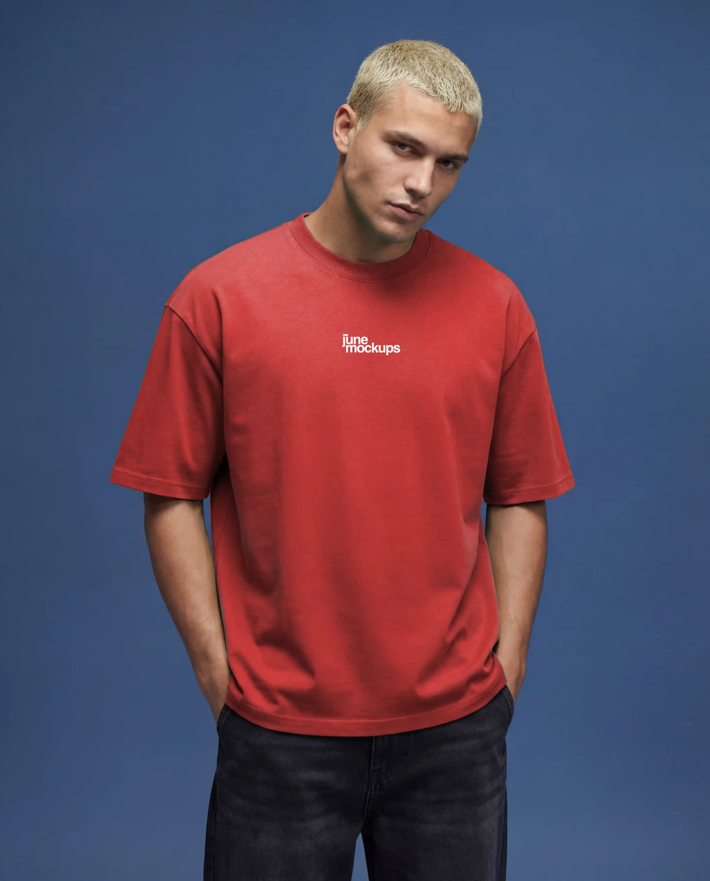 Red oversized t-shirt mockup front close-up showing centered logo print, realistic fabric folds, soft lighting and natural shadows in studio environment with blue background, ideal for streetwear branding, apparel design preview and high quality mockup presentation.