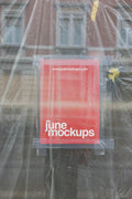 A red A4 poster mockup taped to a window behind transparent plastic foil, with visible tape strips, reflections, wrinkles and construction-like textures, creating a raw urban poster scene for branding, flyer design, art prints and street campaign presentations.