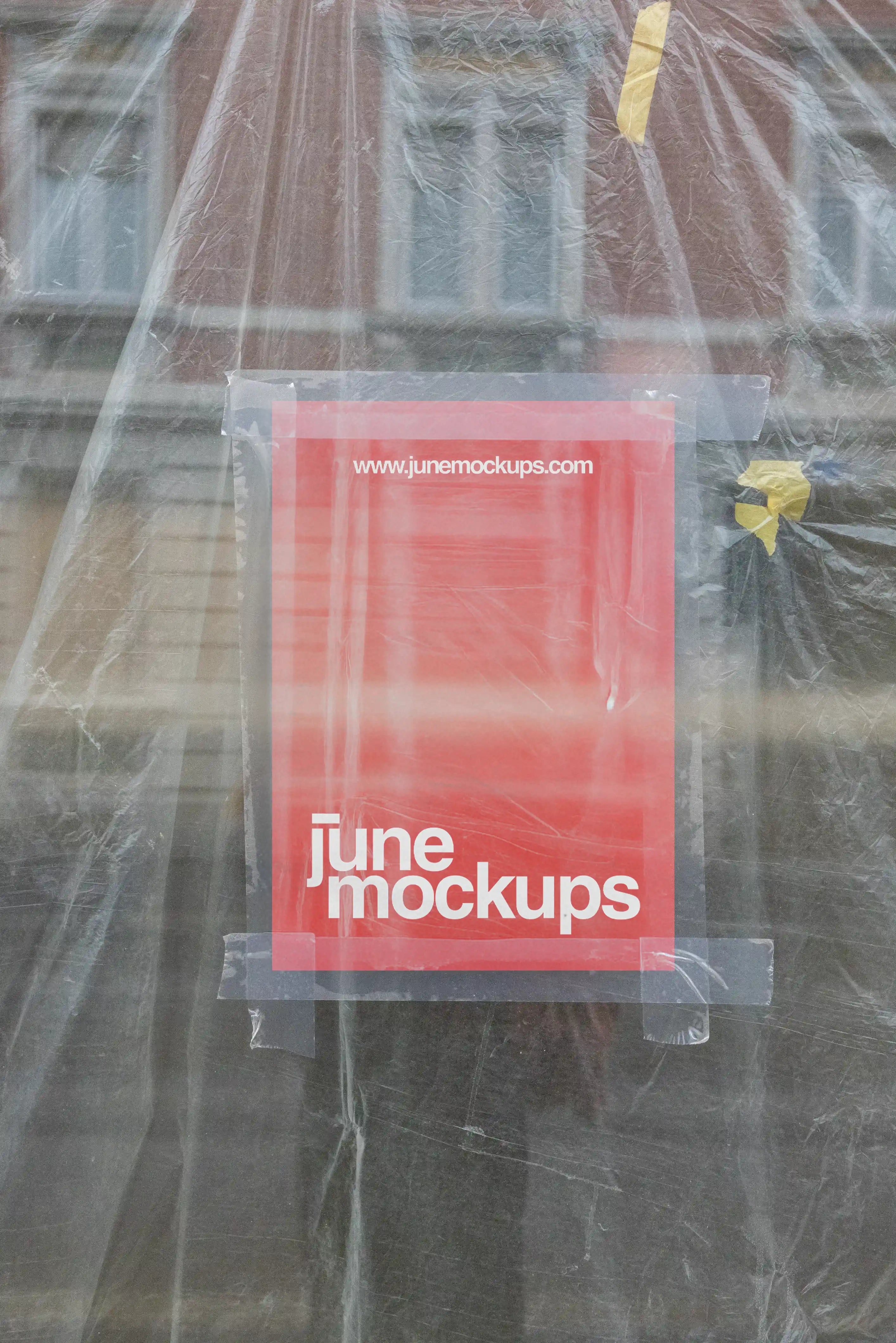 A red A4 poster mockup taped to a window behind transparent plastic foil, with visible tape strips, reflections, wrinkles and construction-like textures, creating a raw urban poster scene for branding, flyer design, art prints and street campaign presentations.