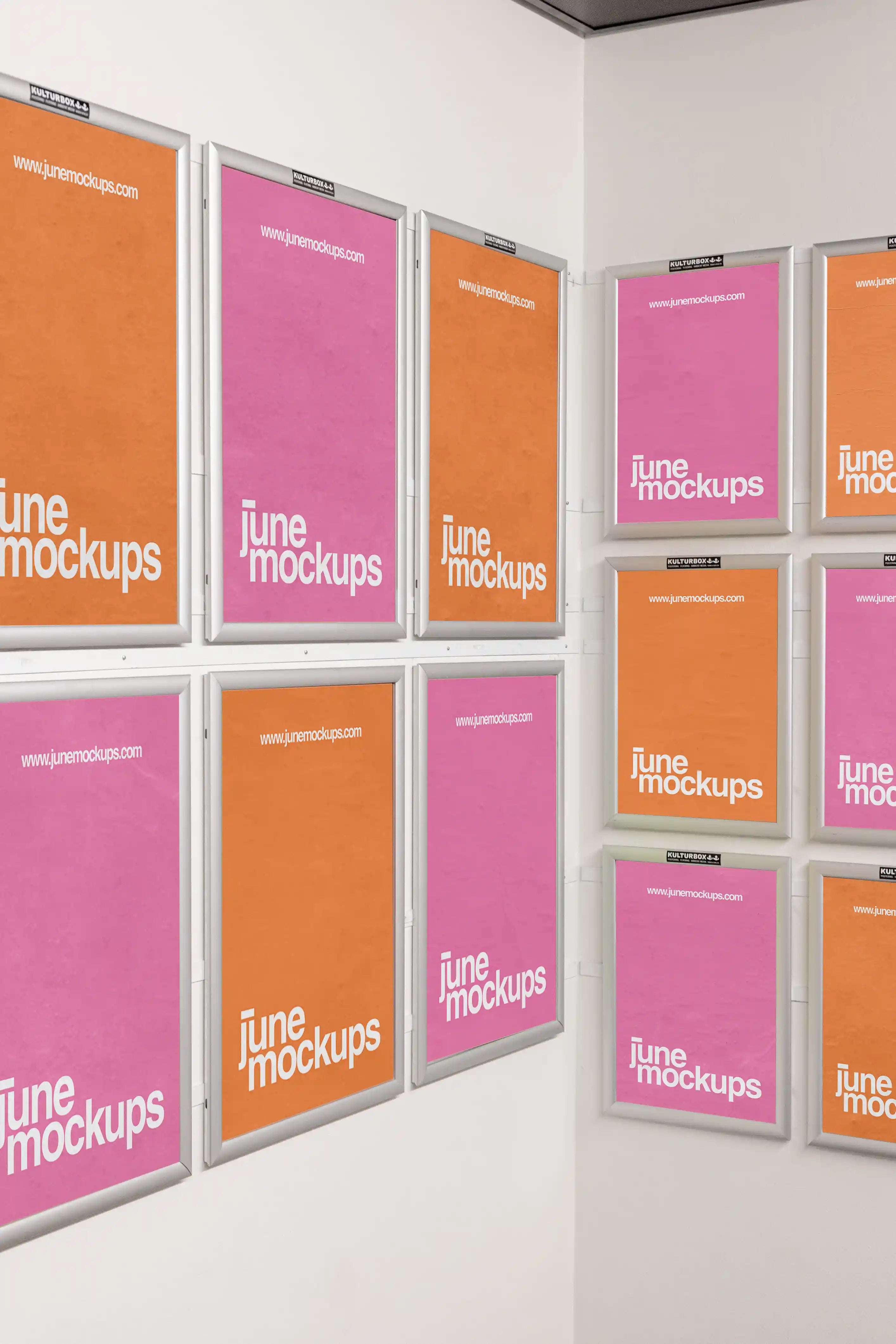Twelve framed DIN poster mockups arranged across two white indoor walls in a corner layout. The posters are displayed in silver frames with pink and orange designs, creating a clean gallery-style wall for presenting multiple poster artworks in one realistic scene.