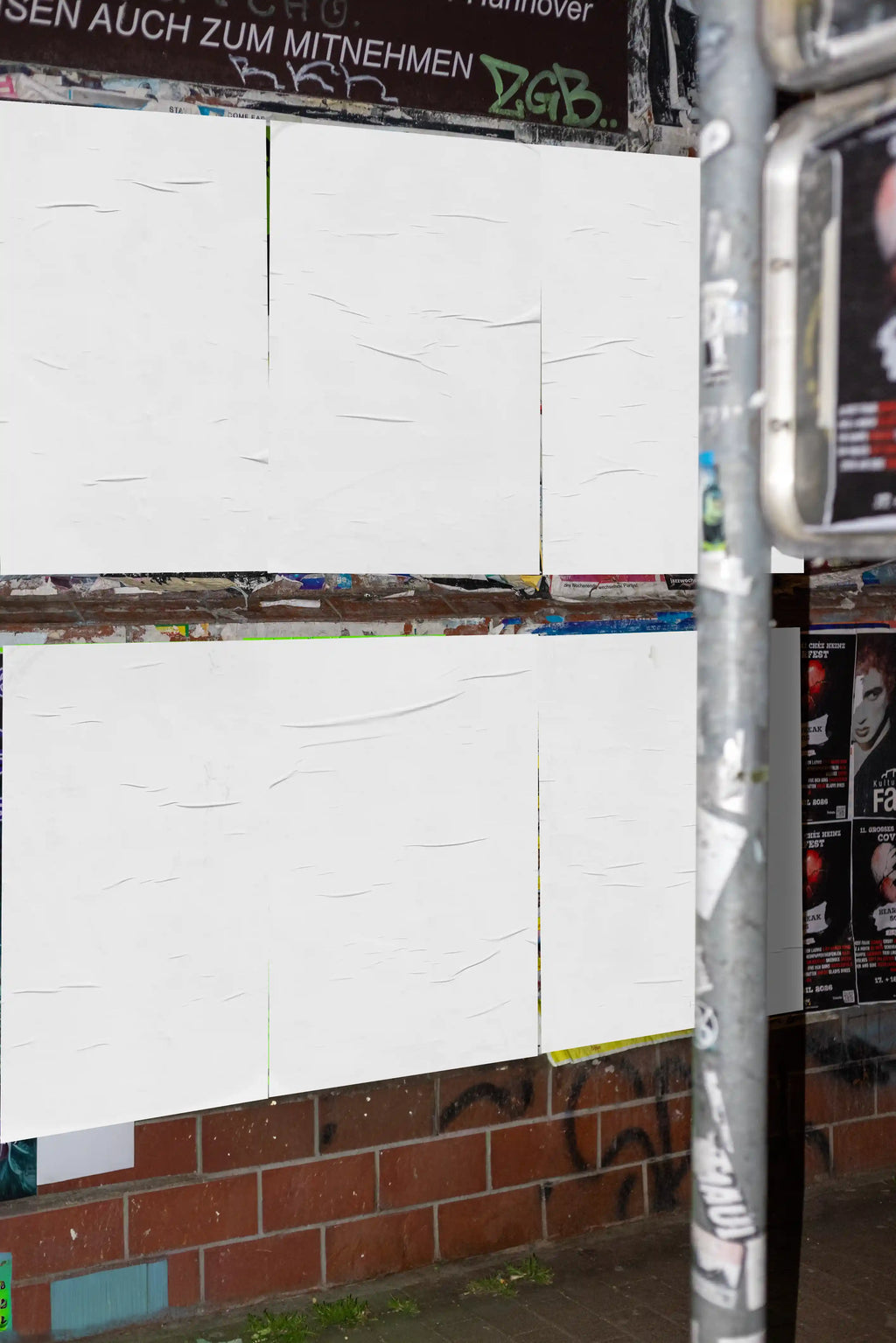 Urban poster mockup with blank posters arranged in a grid on a textured street wall, perfect for clean and realistic design presentations.