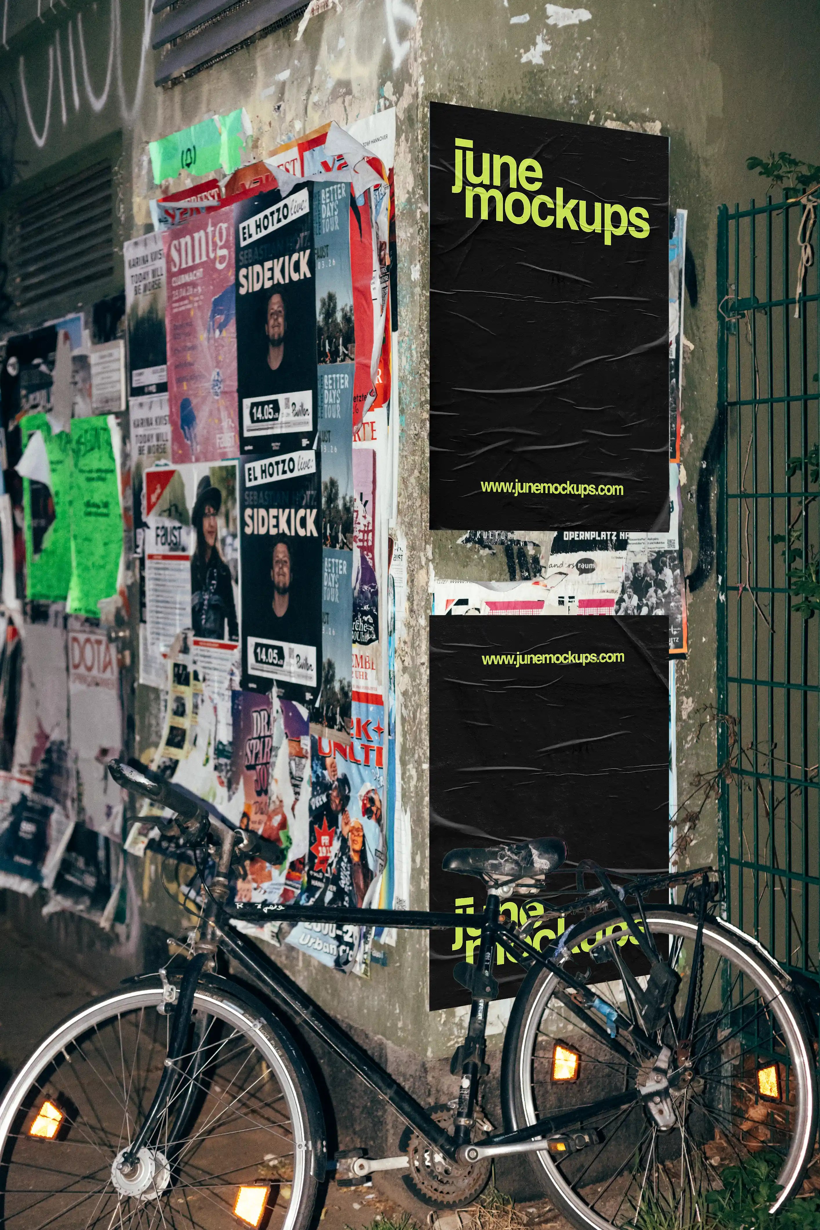 Urban poster mockup featuring a purple street poster on a grunge wall with layered posters and a bicycle in the foreground, showcasing realistic outdoor advertising in a raw city environment.